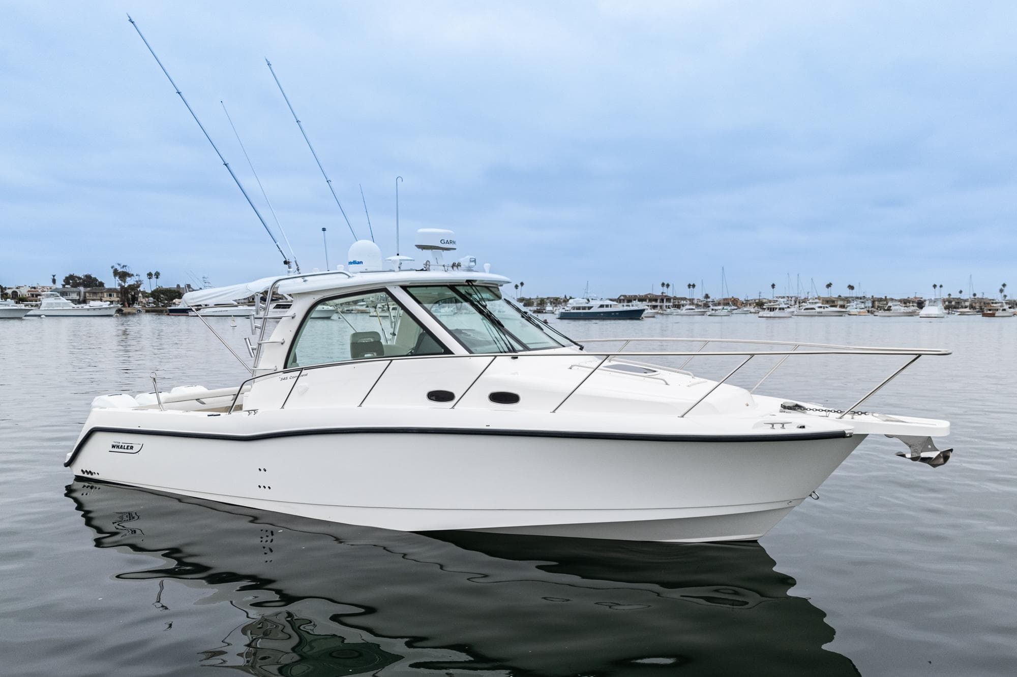 2008 Boston Whaler 345 Conquest boat on calm water, side view.