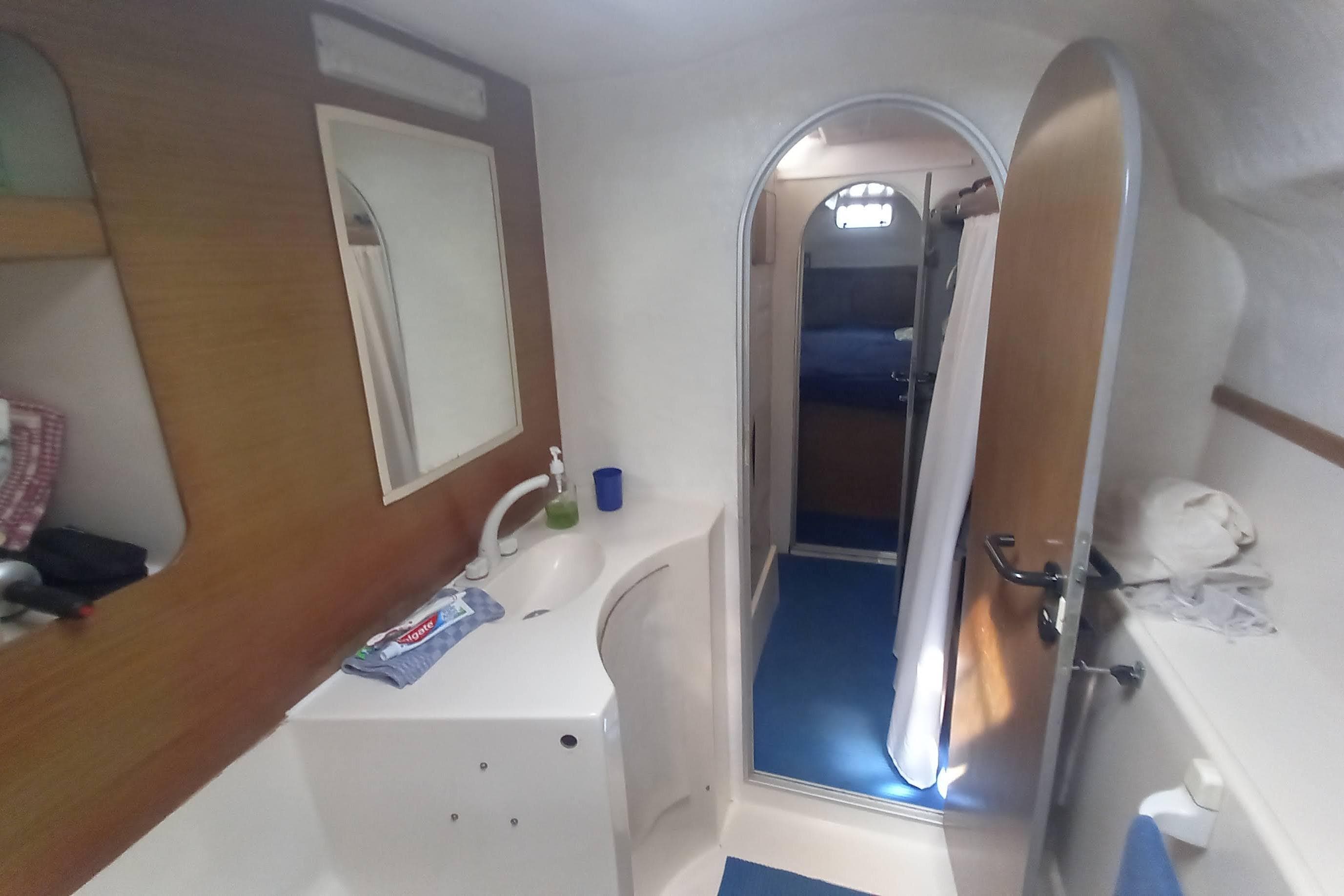 Interior of 1993 Fountaine Pajot Antigua 37 yacht bathroom with sink and mirror.