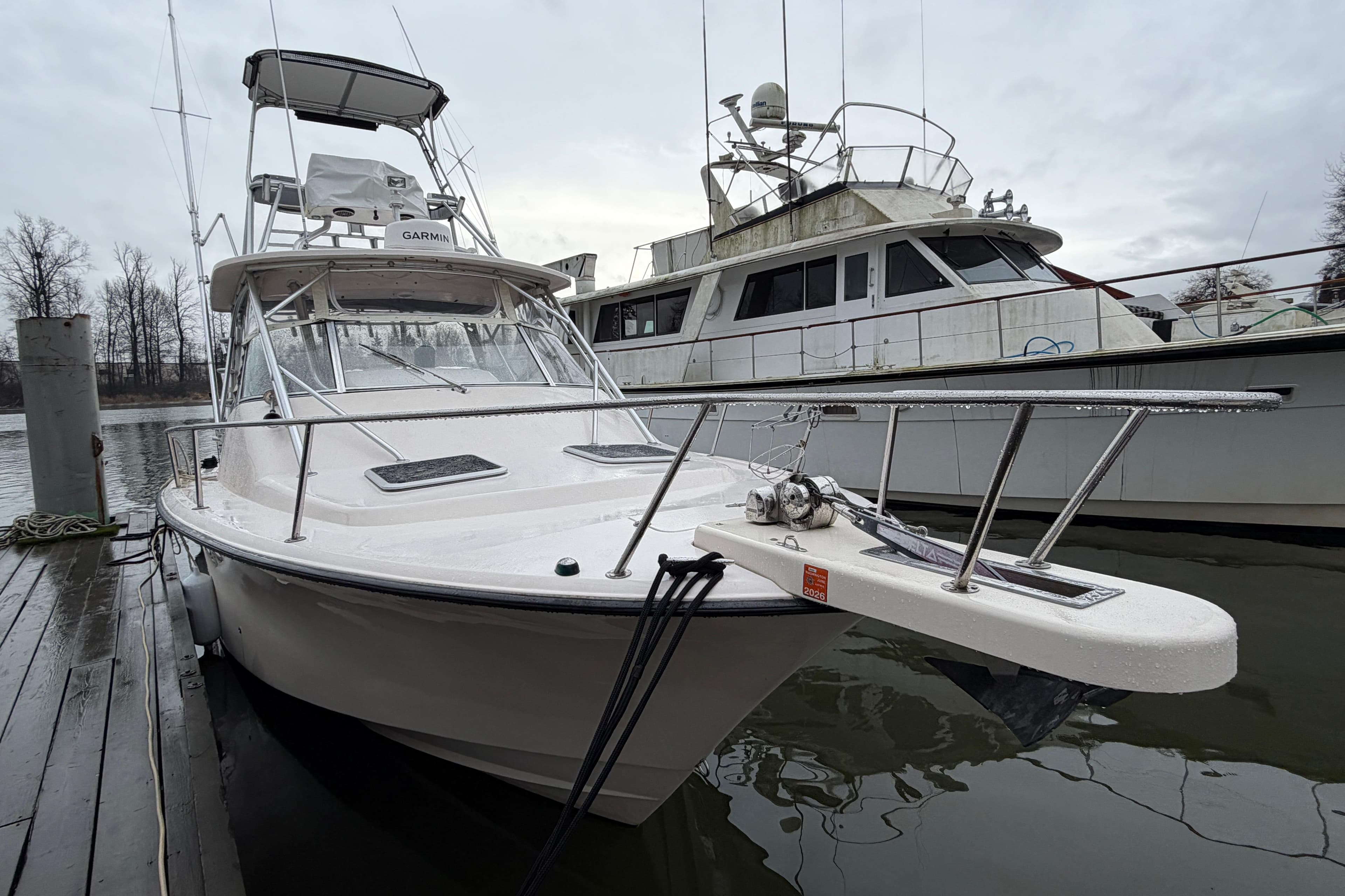 2004 Grady-White Express 330 boat docked on a cloudy day.