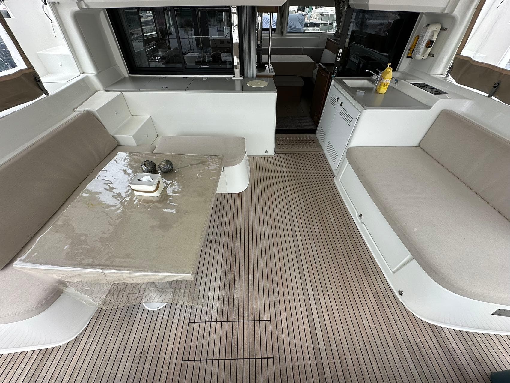 Spacious interior of 2021 Lagoon 46 catamaran with modern seating and dining area.