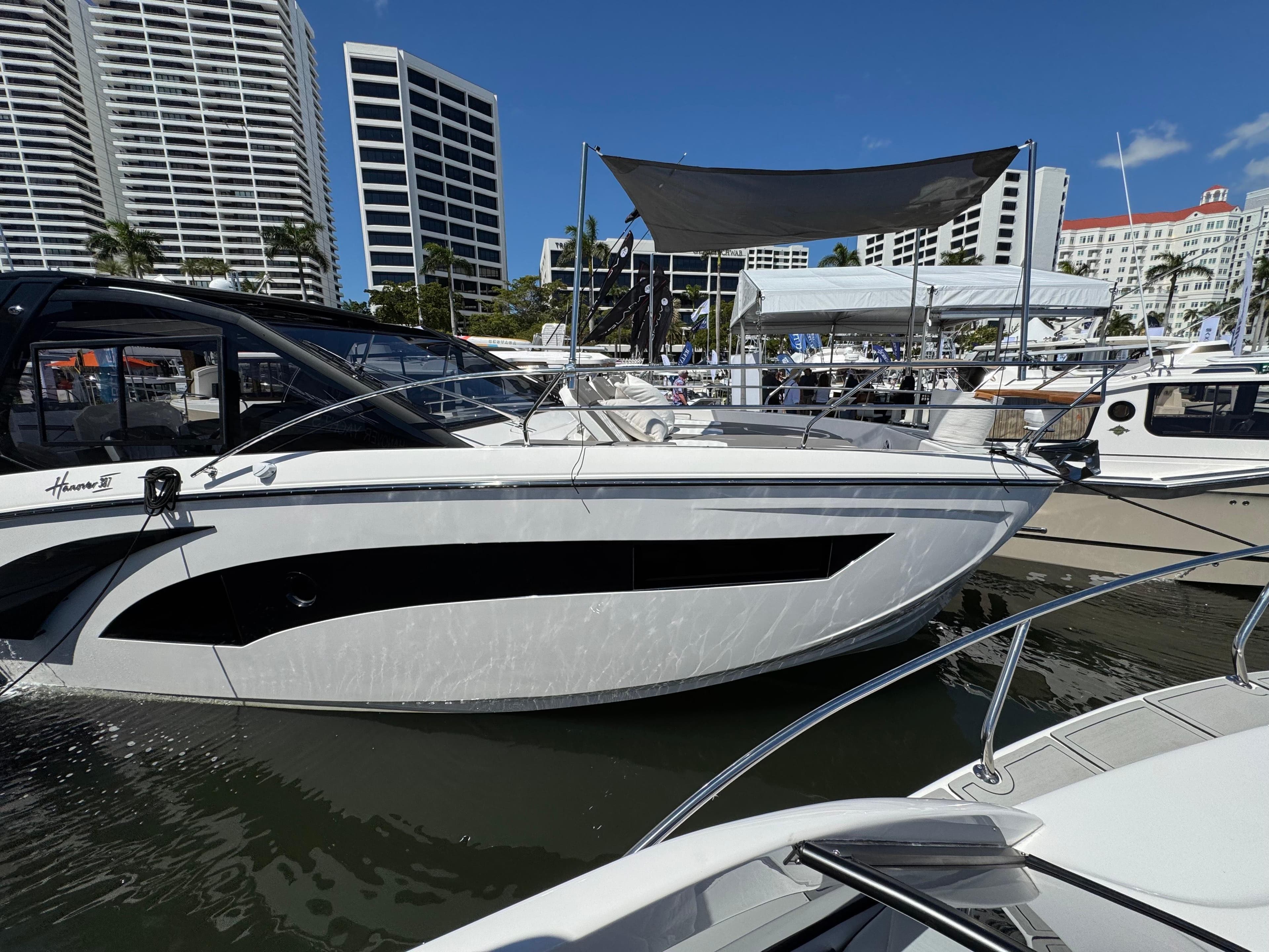 2025 Hanover 387 yacht docked at marina with modern buildings in background.