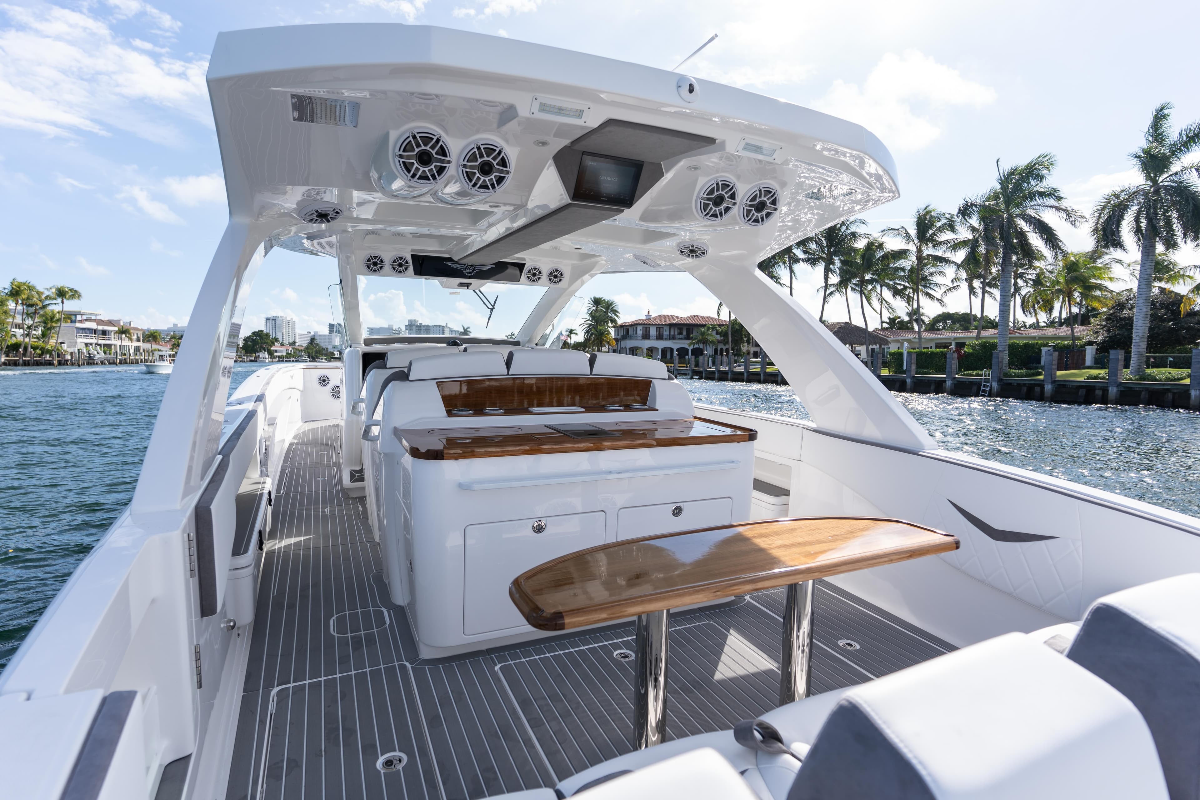 Luxury interior of 2026 Deep Impact 499 Sport boat on a sunny waterfront.