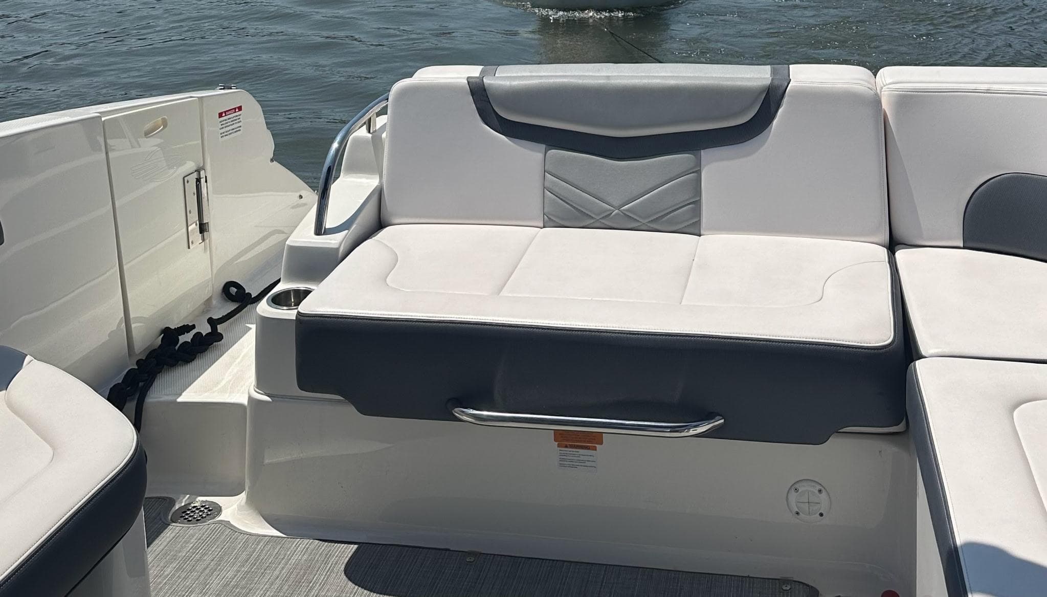 2017 Chaparral 287 SSX boat interior with white and gray seating, on water.