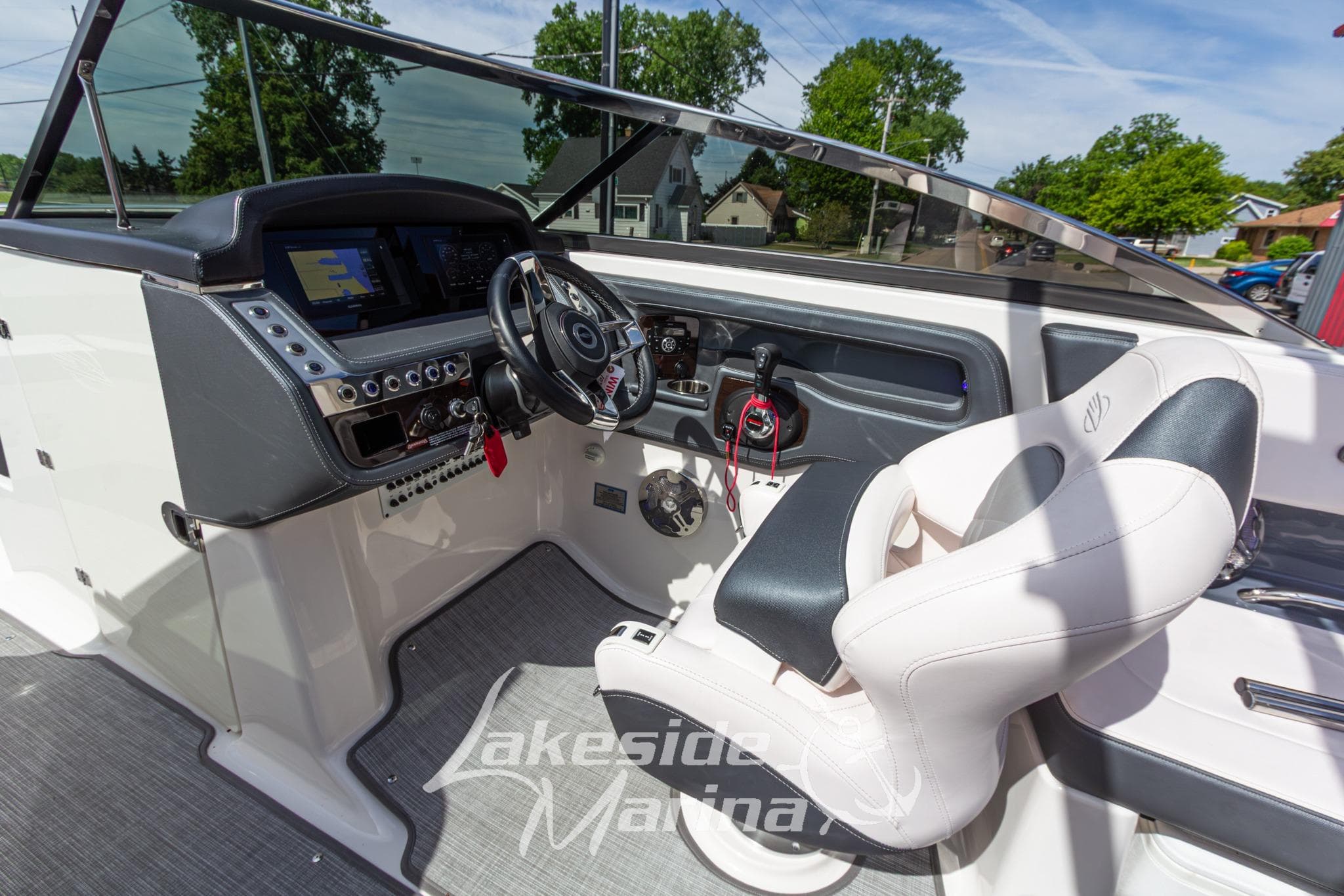 2021 Chaparral 287 SSX boat cockpit with steering wheel and control panel.