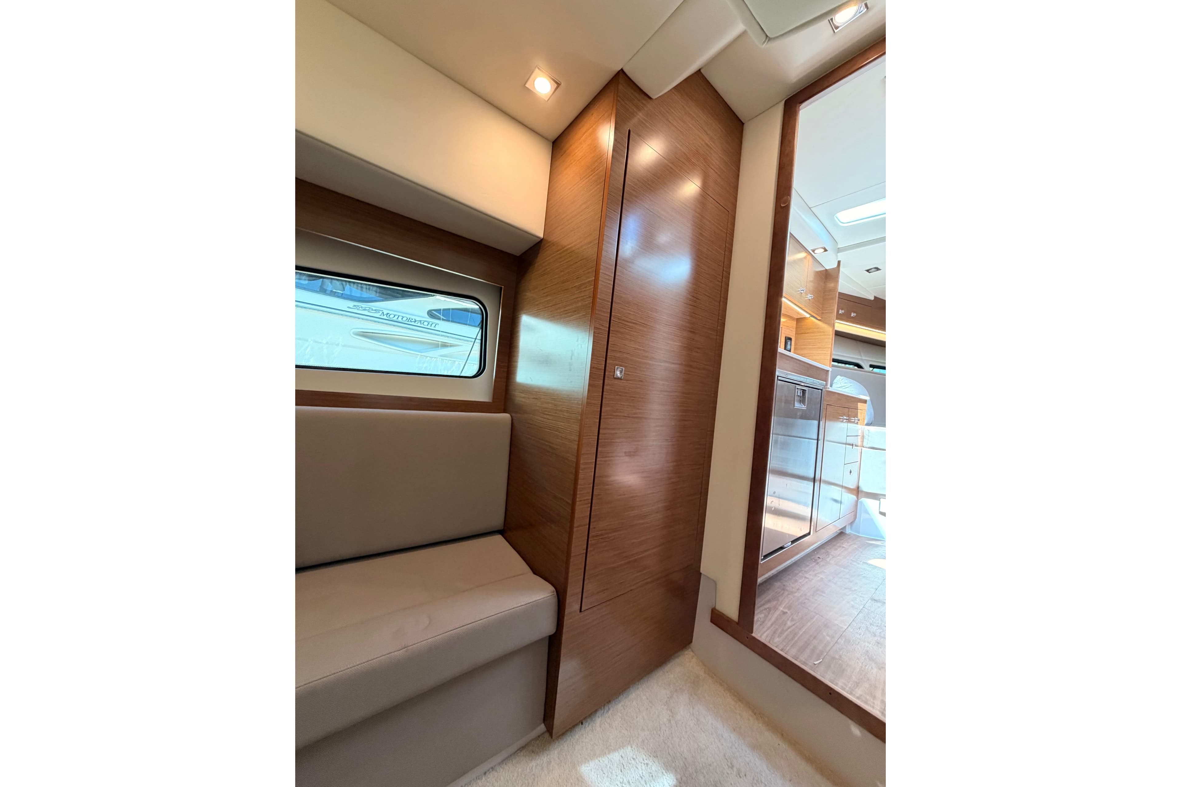 Interior of 2020 Cruisers Yachts 390 Express Coupe, featuring modern wood paneling and seating.
