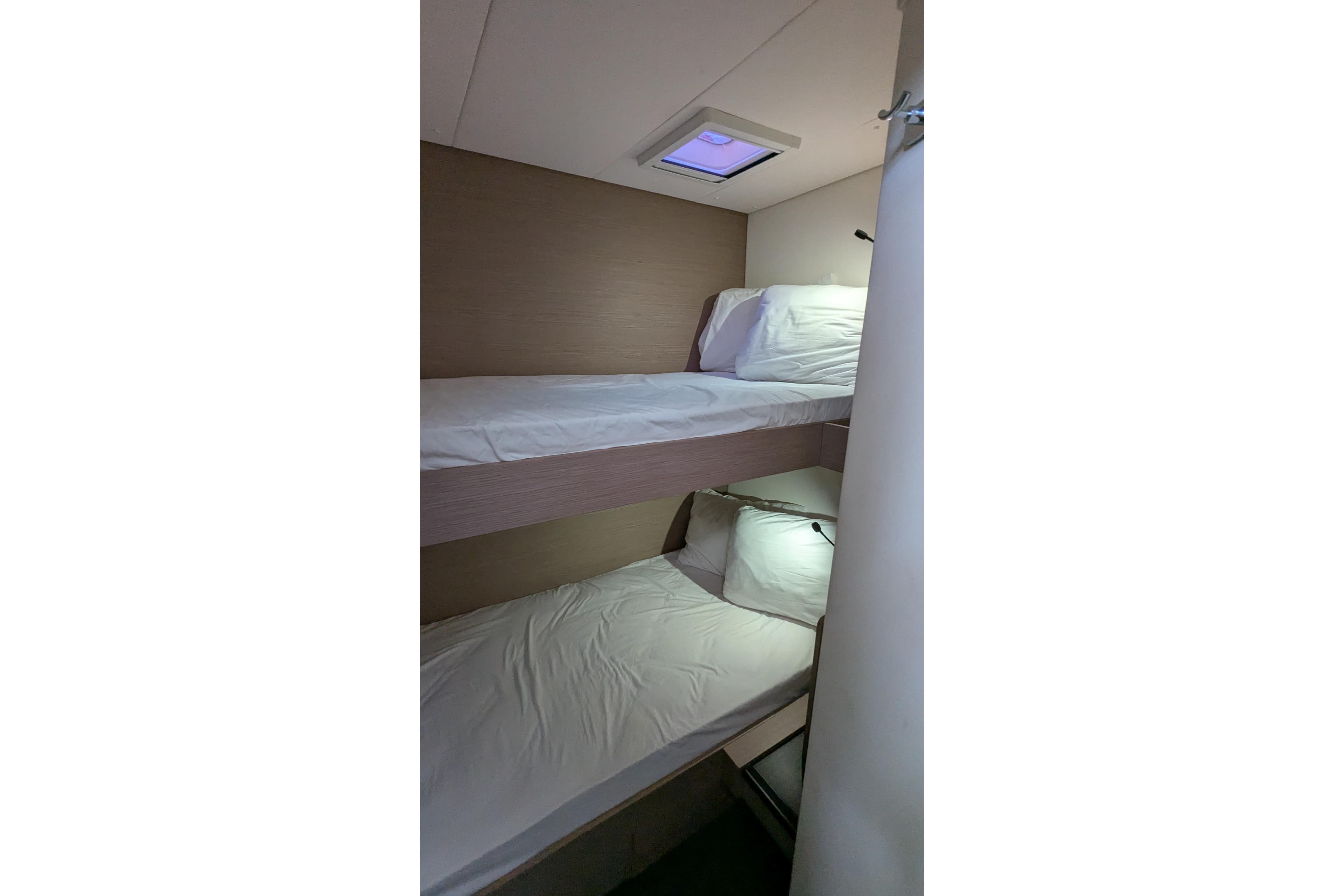 Bunk beds in 2020 Fountaine Pajot Saona 47 yacht cabin, featuring modern design and lighting.