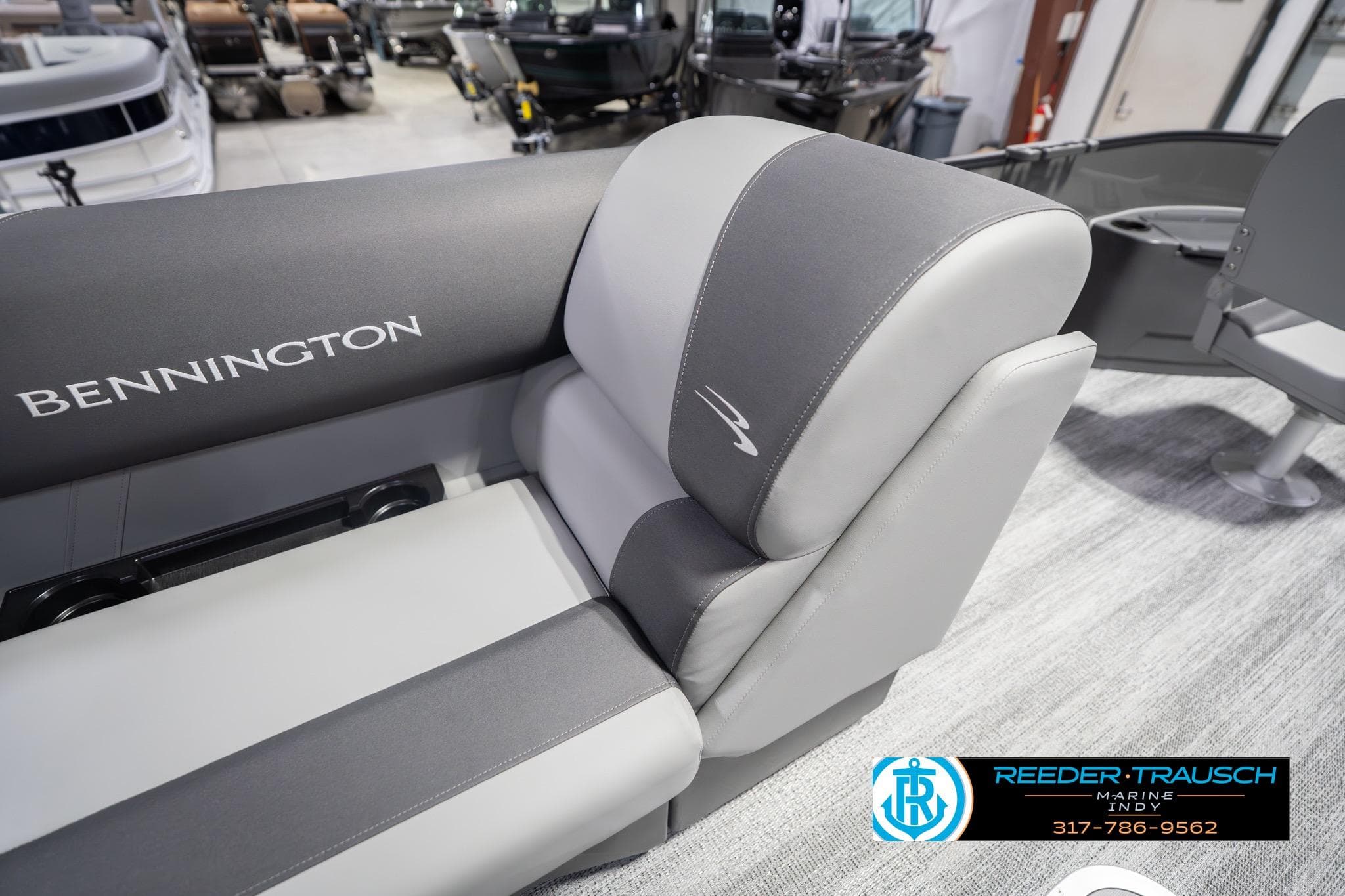2026 Bennington 22 SF boat interior with gray seating at Reeder-Trausch Marine showroom.