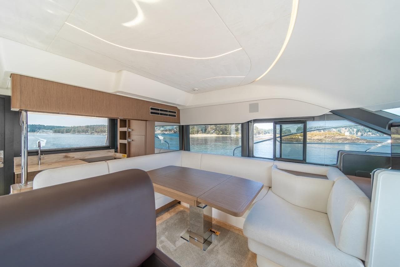 Luxurious interior of 2025 Prestige F4.9 yacht with panoramic windows and elegant seating.