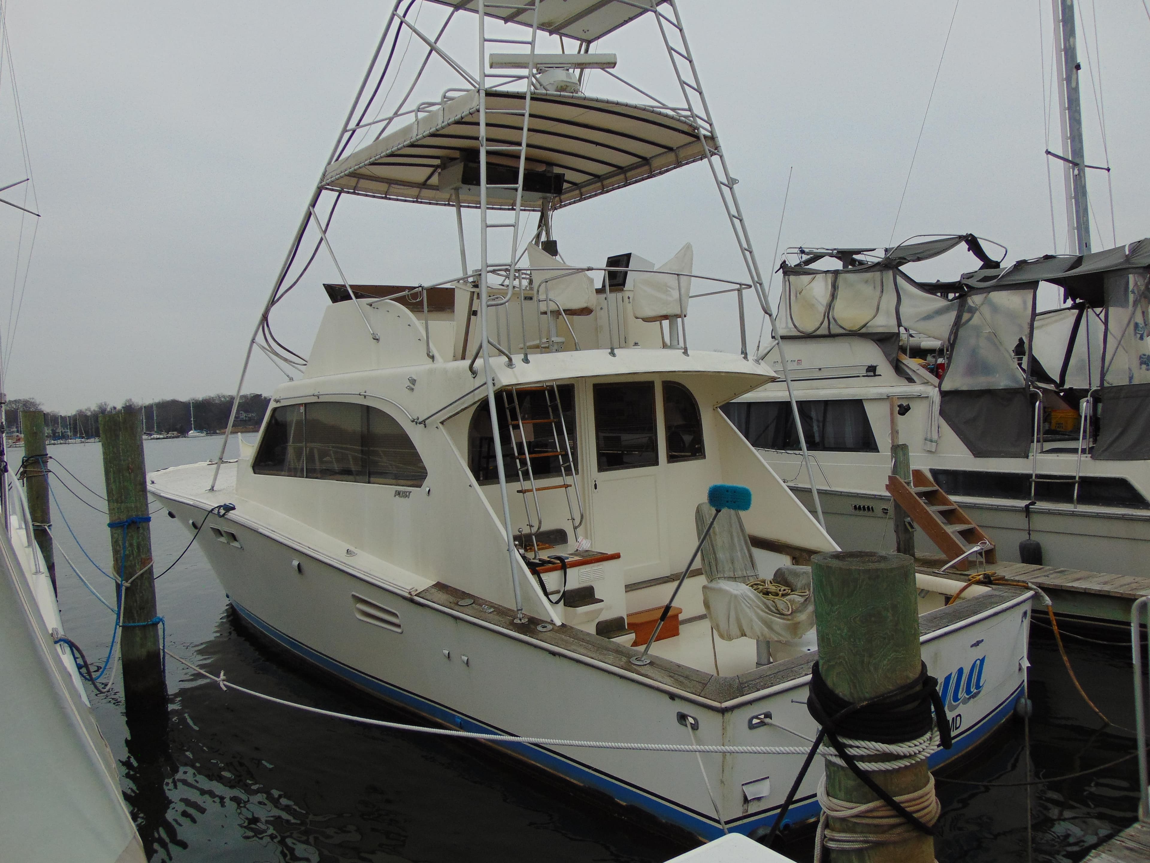 1981 Post 46 Sportfish boat docked, featuring a flybridge and spacious deck.