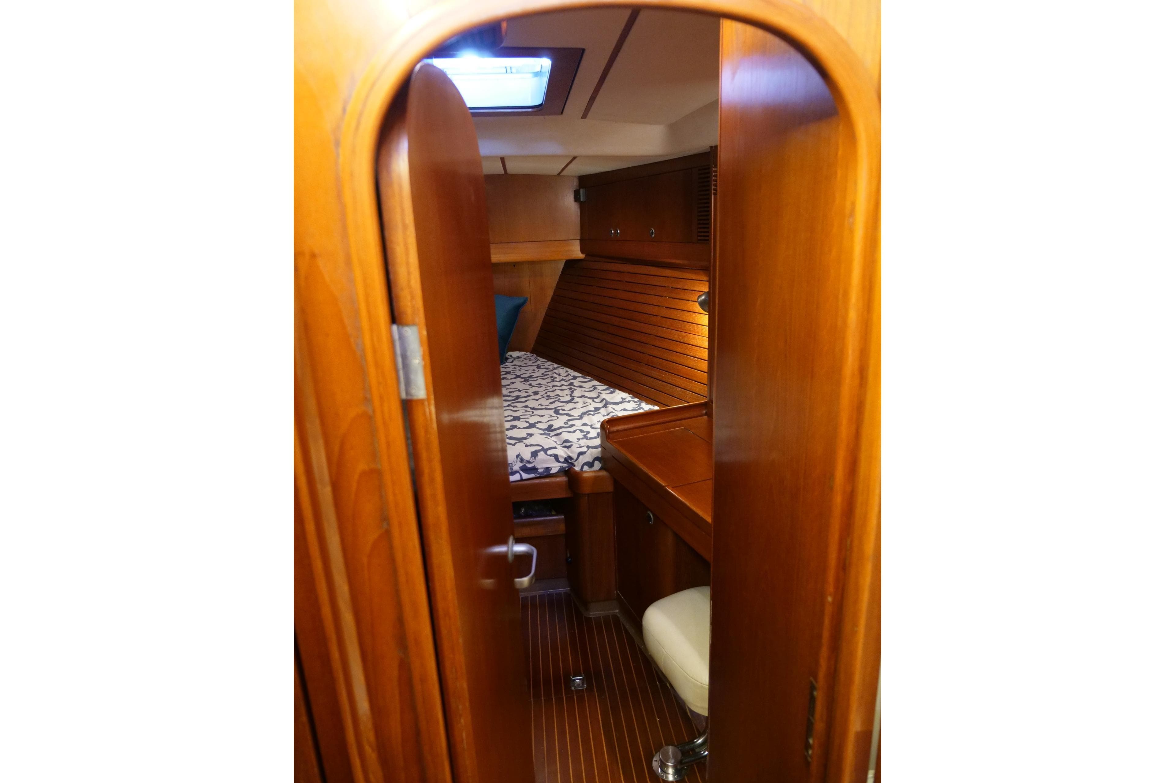 Cozy cabin interior of 1992 Nautor Swan 55 yacht with wooden furnishings.