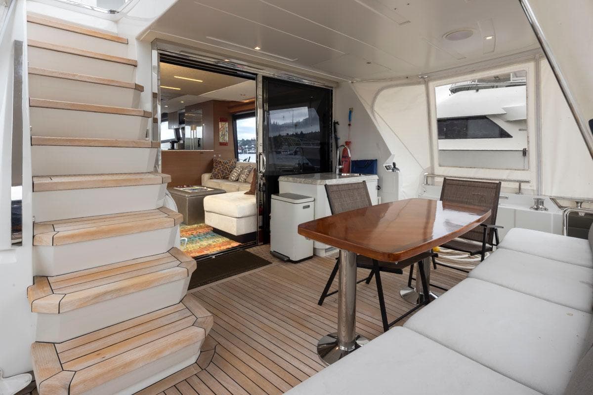 2017 Ocean Alexander 70E Motoryacht interior with seating, table, and stairs.