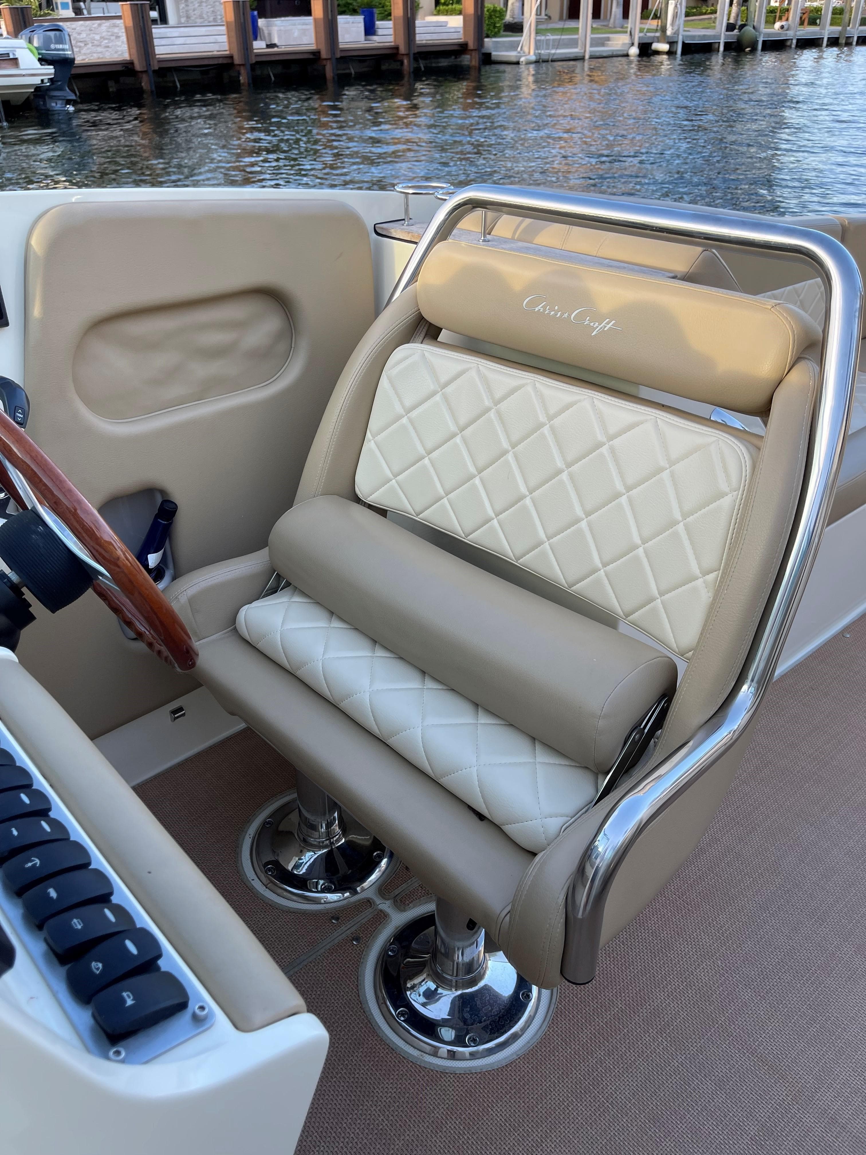 Luxurious seating on a 2015 Chris-Craft 32 Launch boat, featuring elegant diamond-pattern upholstery.
