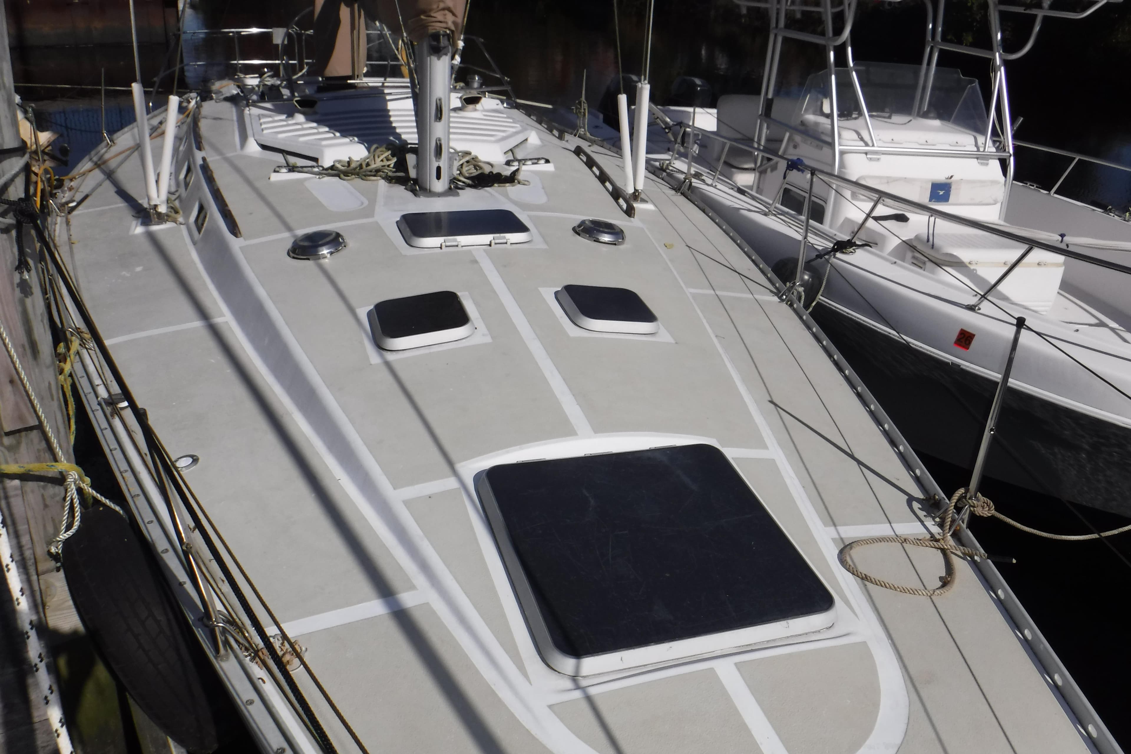 1986 Hunter Legend 40 sailboat deck view, docked alongside other boats.