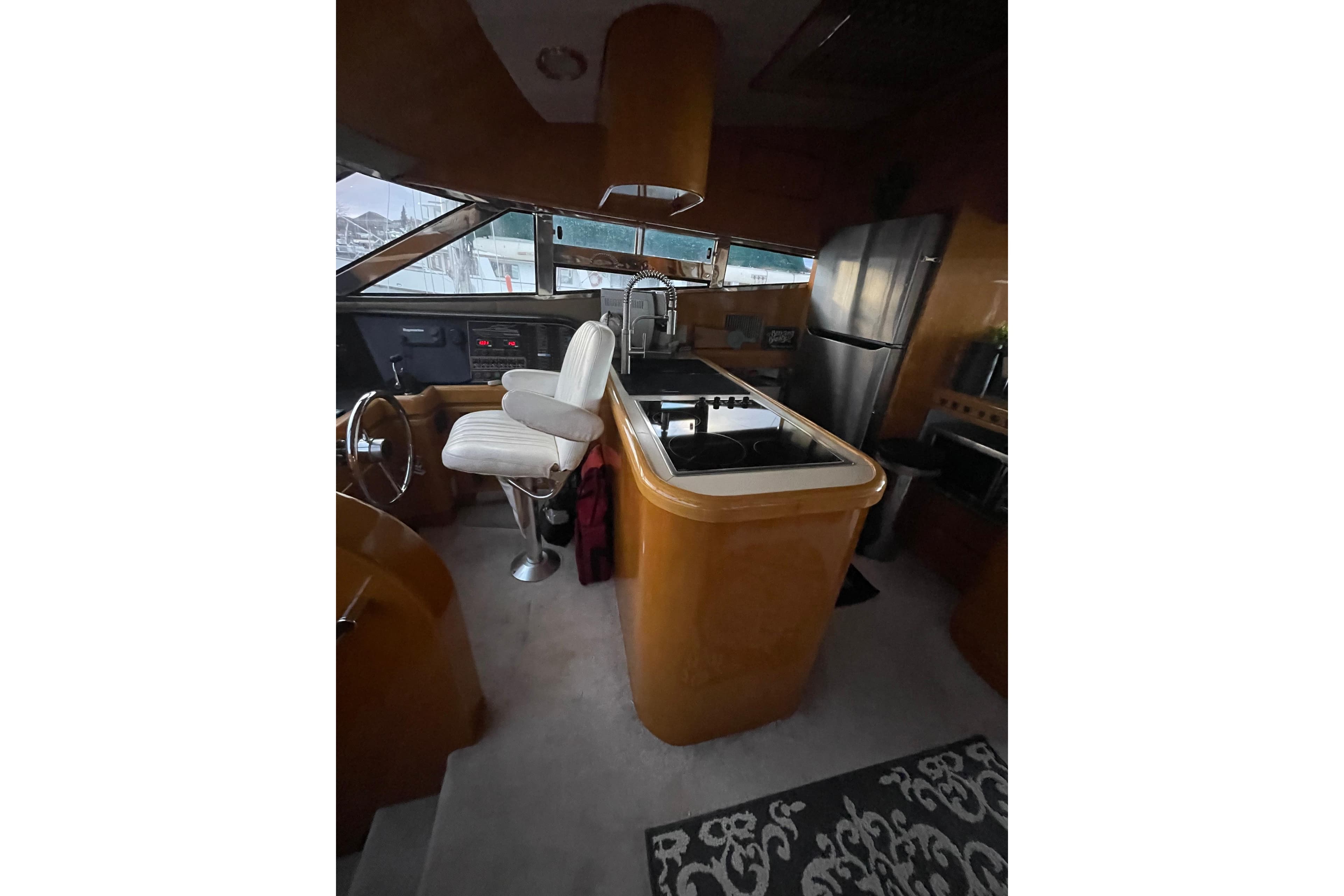 Interior of a 1994 Johnson High-Tech 65 Euro yacht with modern kitchen and steering area.