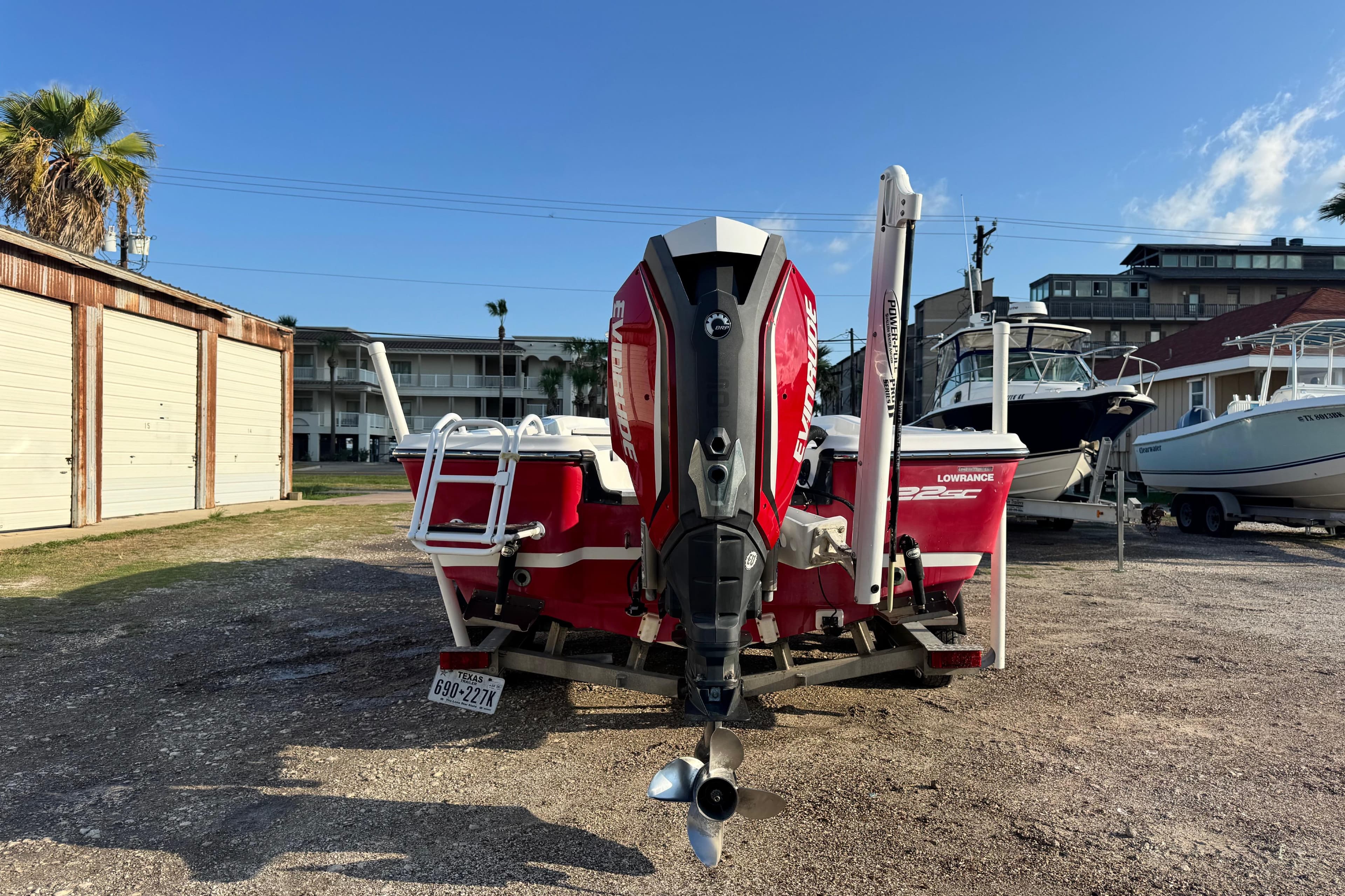 2015 Epic 22 Sport Console boat with Evinrude engine, parked outdoors.