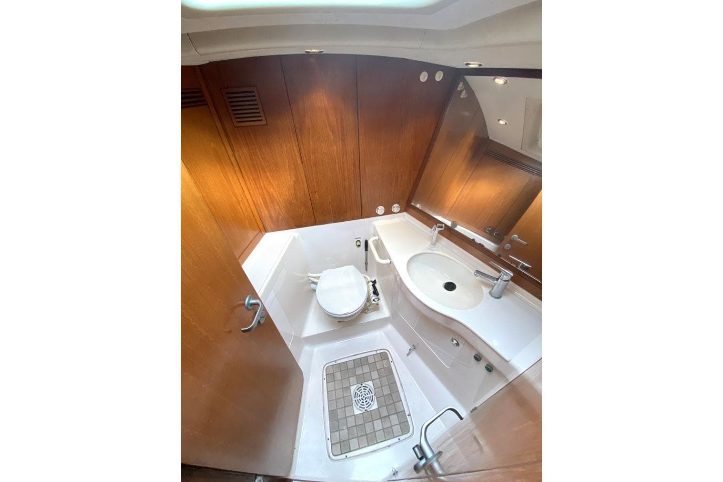 Luxurious bathroom in 1996 Nautor Swan 48 yacht with wooden accents and modern fixtures.