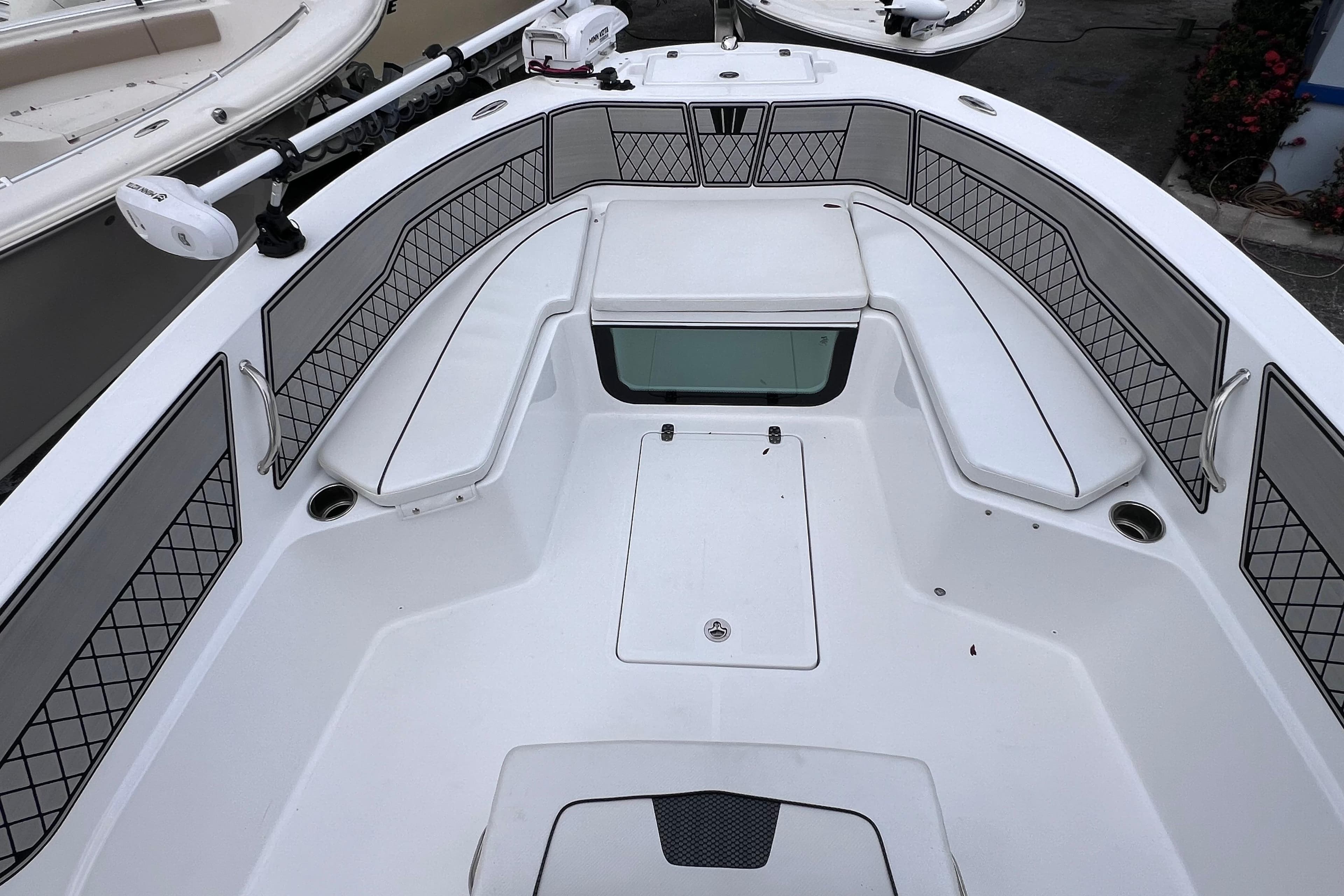 2024 Wellcraft 202 Fisherman boat interior with cushioned seating and storage compartments.