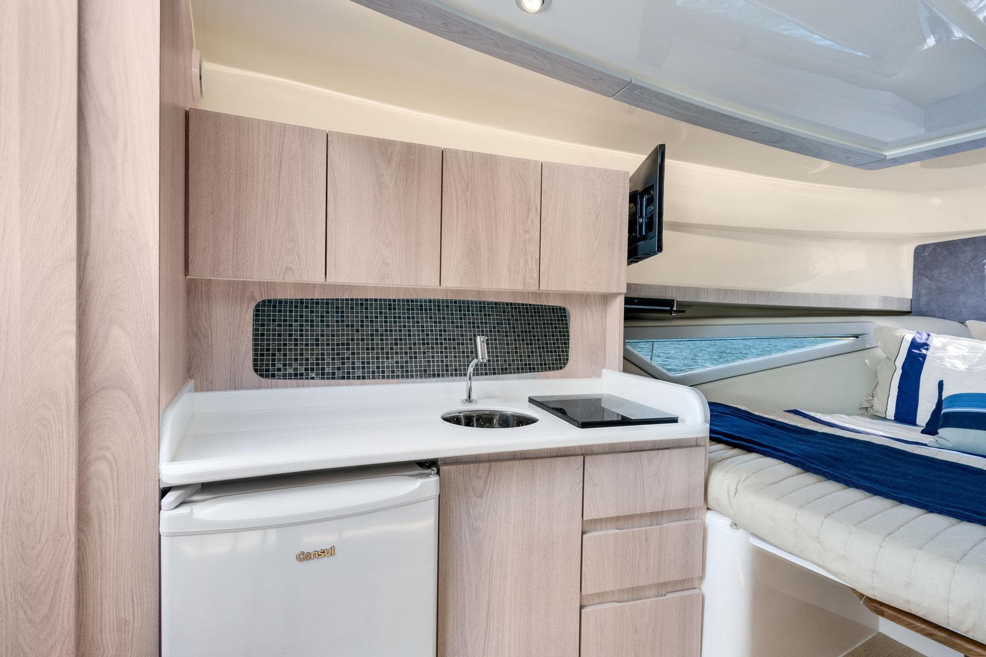 Modern Hanover 375 yacht interior with kitchenette and cozy sleeping area, 2026 model.
