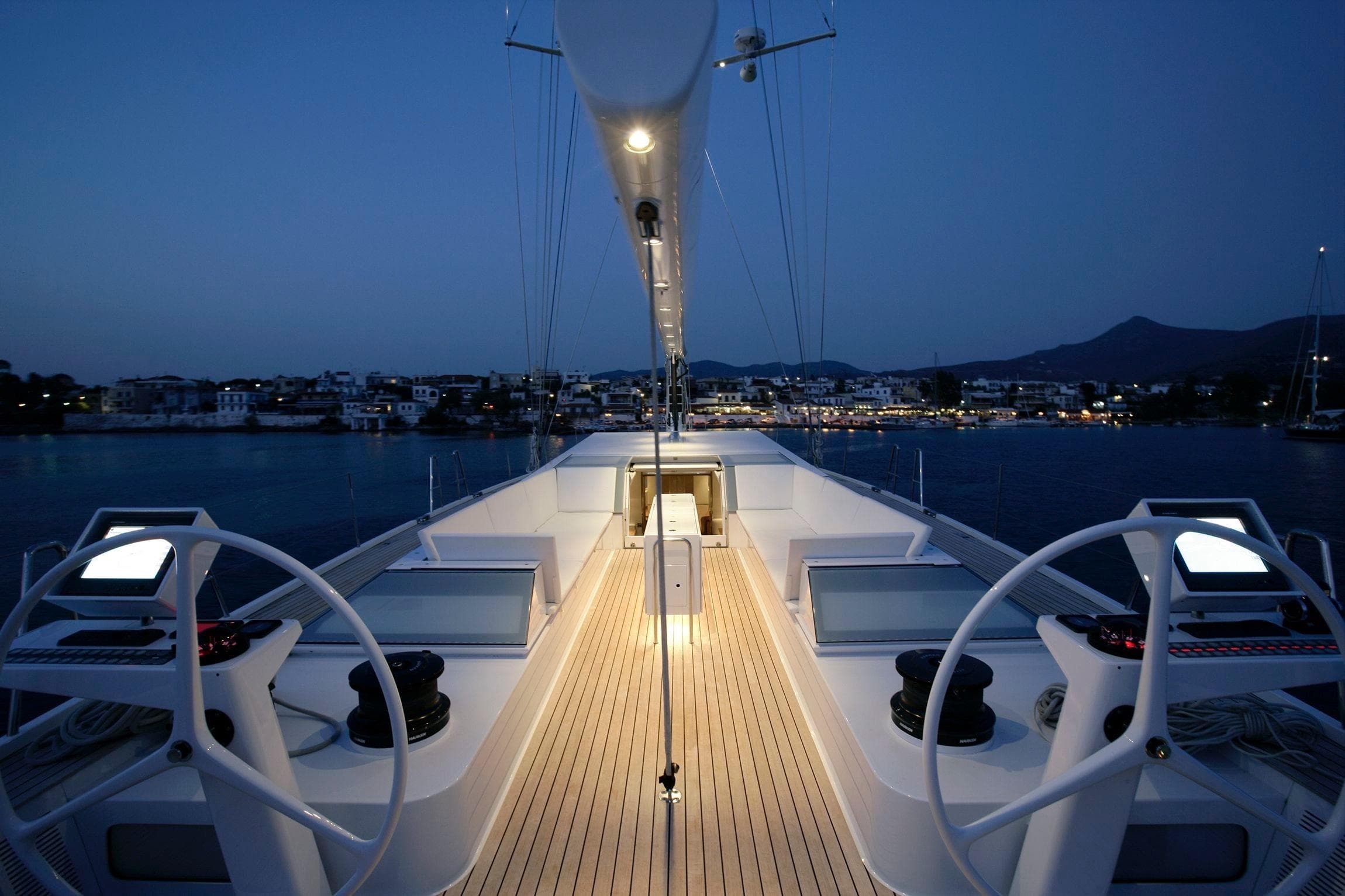 Luxurious 2008 Nautor Swan 82 yacht deck at dusk, featuring elegant design and serene waterfront view.