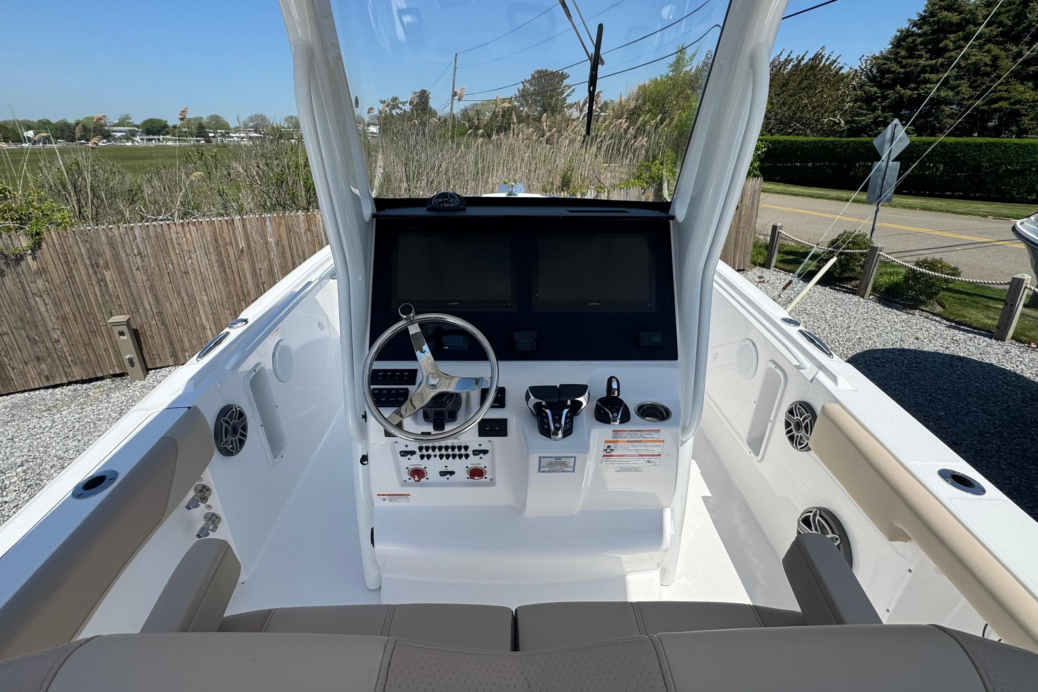 2026 Edgewater 262CC boat cockpit with steering wheel and control panel.