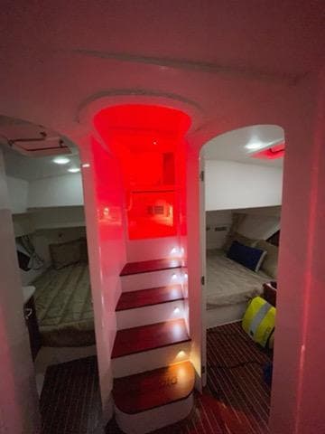Interior cabin of 2017 Intrepid 475 Sport Yacht with red ambient lighting.
