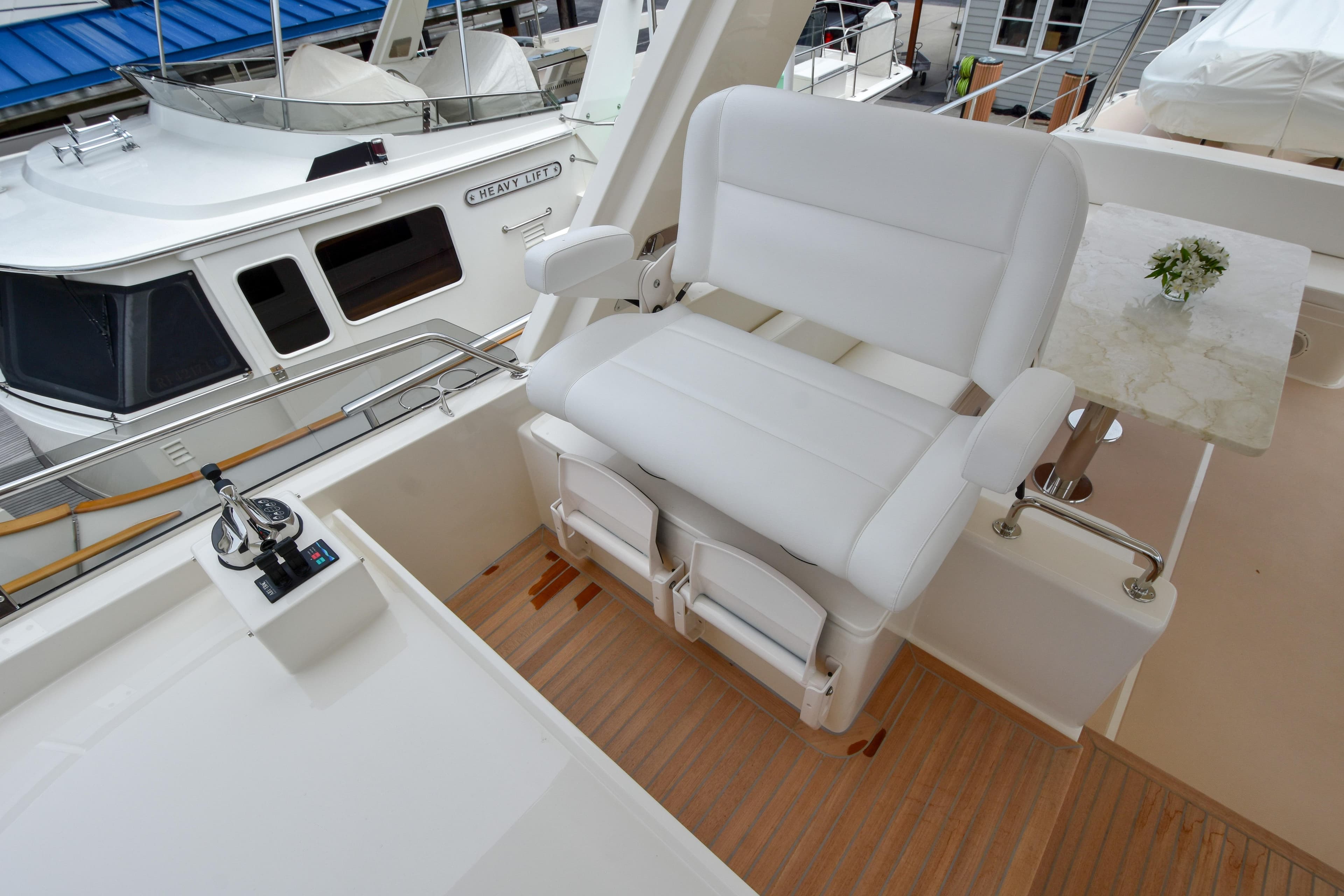 Luxury seating on 2020 Fleming 78 yacht deck with control panel.