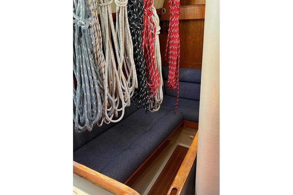 Interior of 1982 C&C Landfall 38 sailboat with ropes and blue seating.