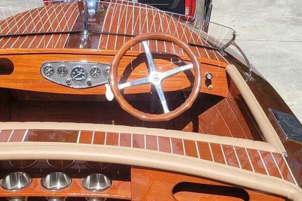 1941 Hacker-Craft Deluxe boat interior with wooden dashboard and steering wheel.