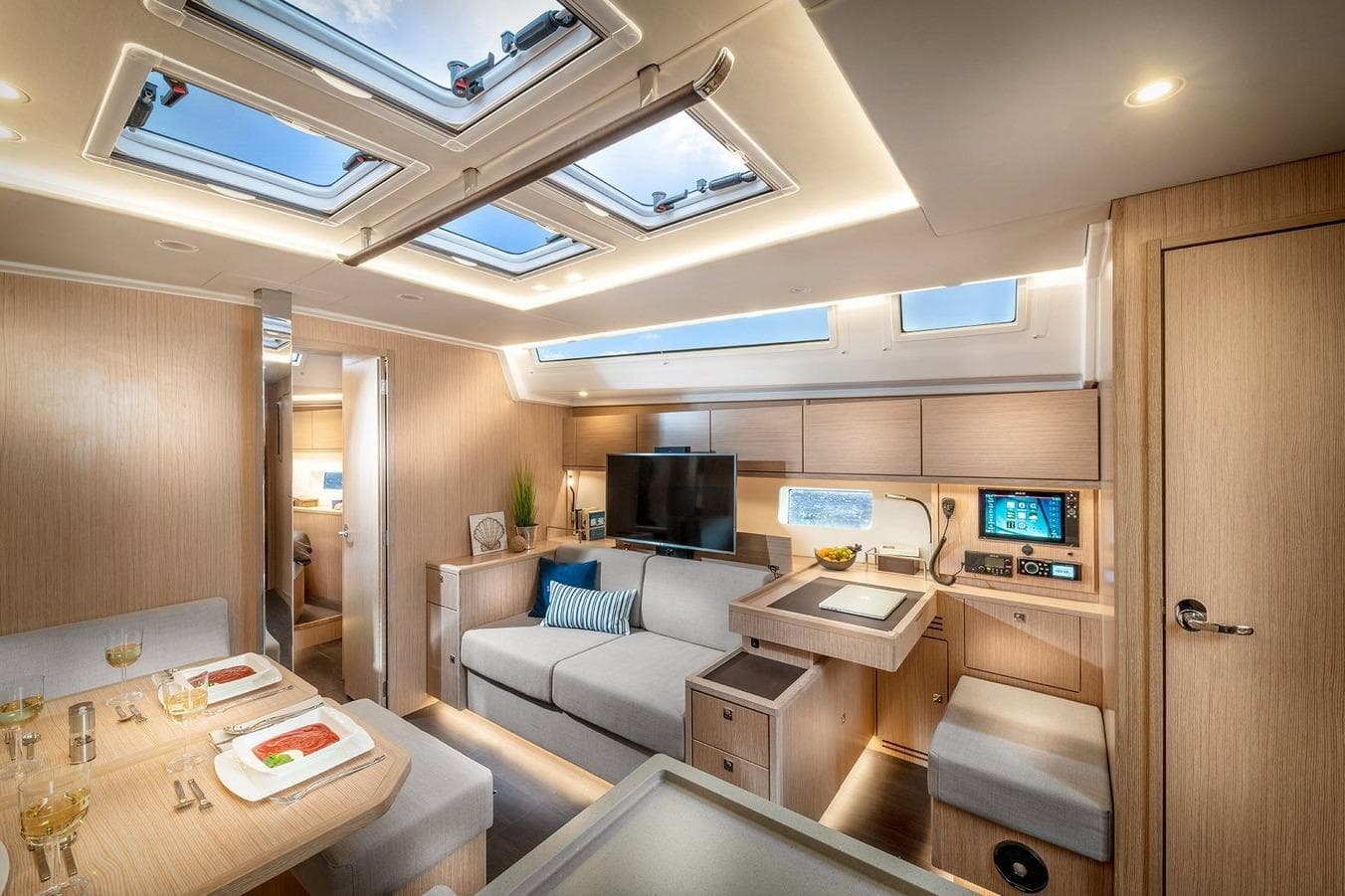 Luxurious interior of 2026 Bavaria C46 yacht with modern furnishings and skylights.