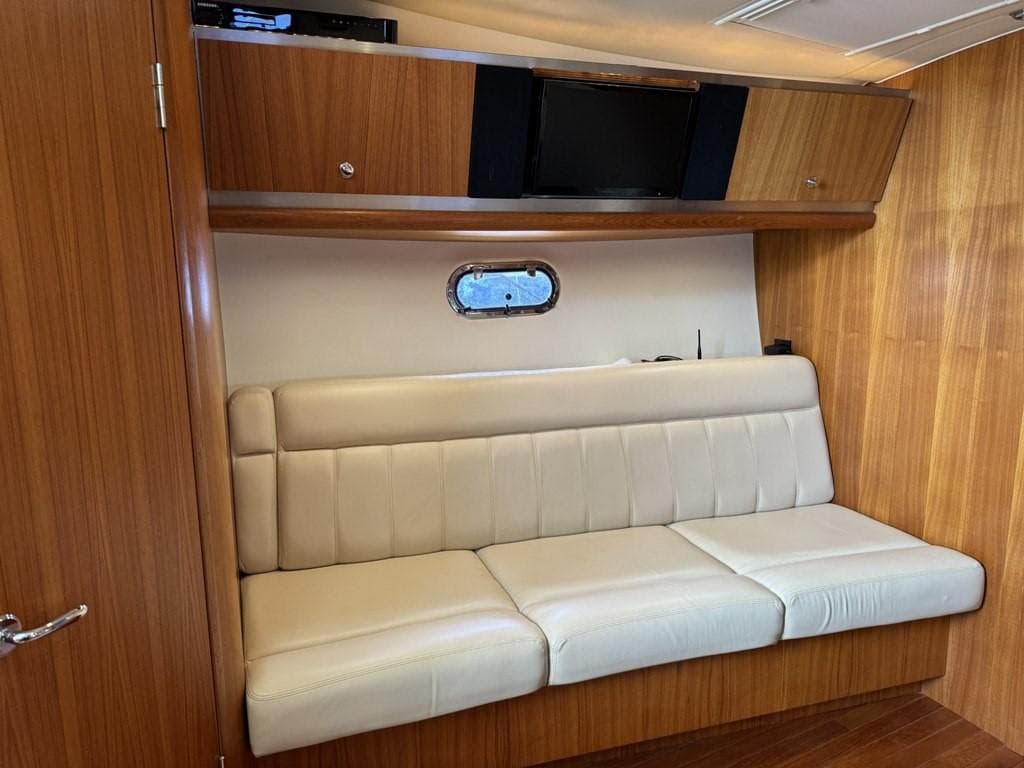 Interior of 2004 Tiara Yachts 3600 Sovran with beige seating and wooden cabinetry.