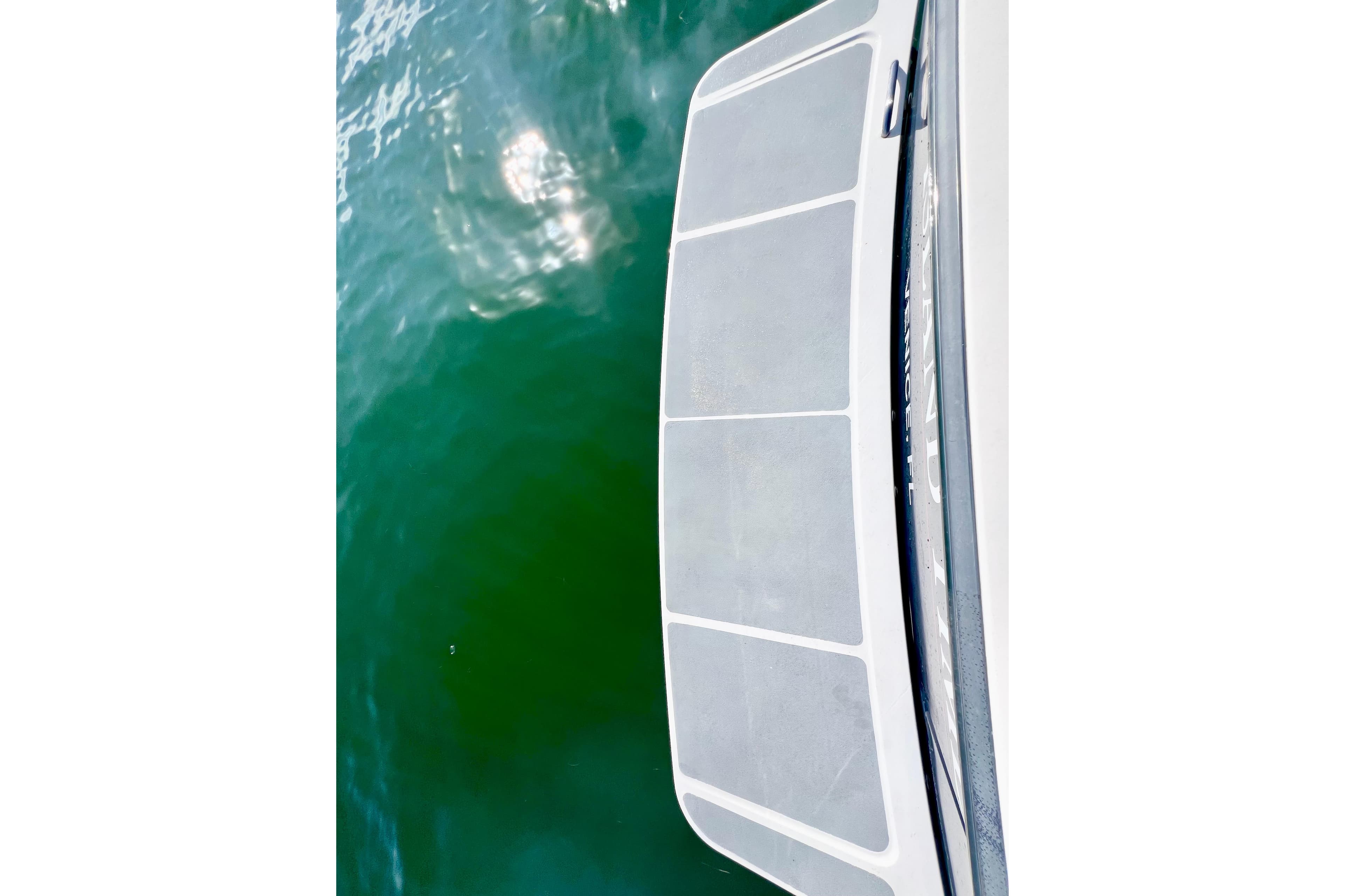 2006 Sabre 38 Hard Top Express swim platform above green water.