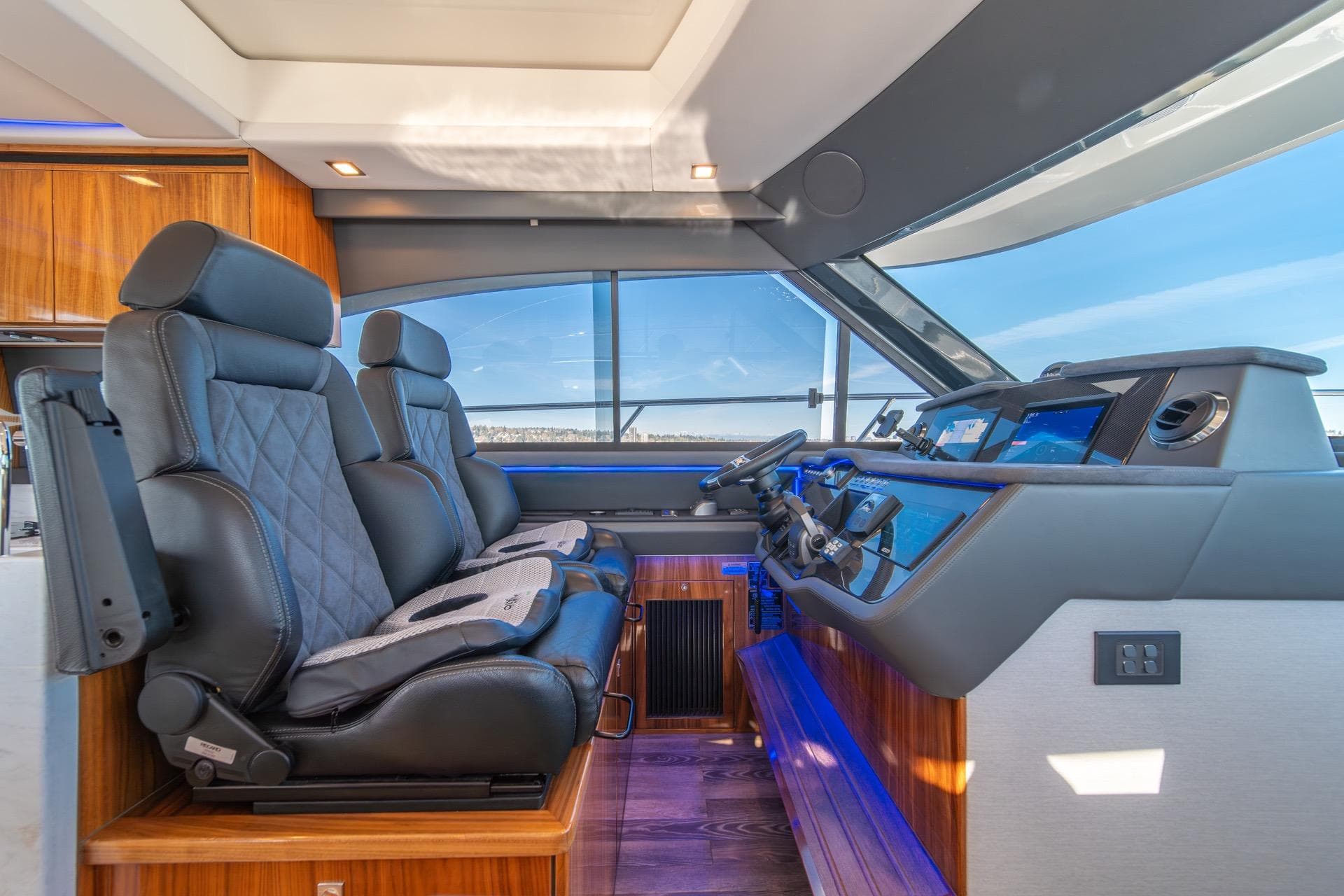 Luxurious interior of 2023 Riviera 4600 Sport Yacht Platinum Edition with leather seating and modern controls.