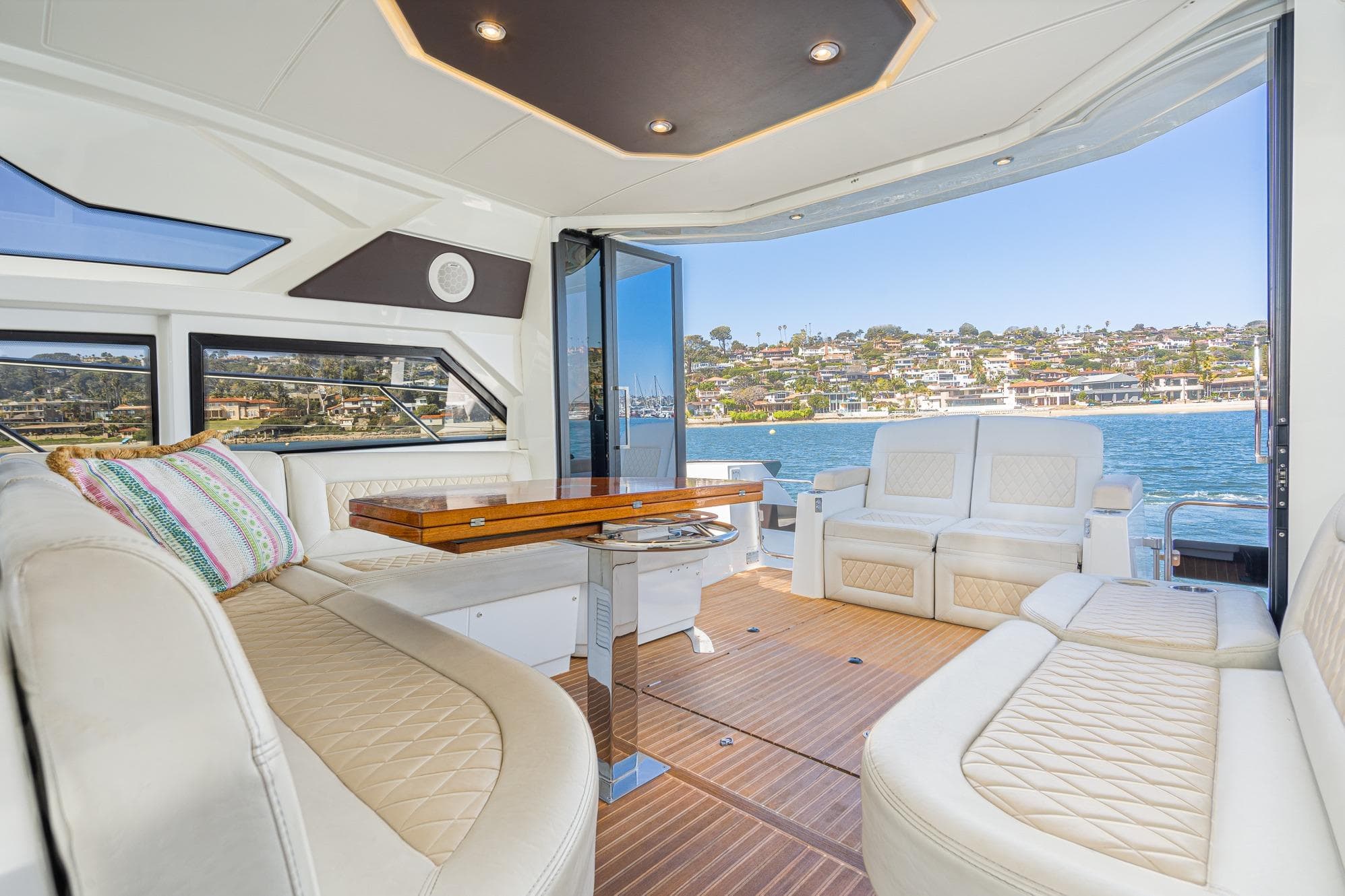 Luxurious interior of 2017 Beneteau Gran Turismo 46 yacht with scenic waterfront view.