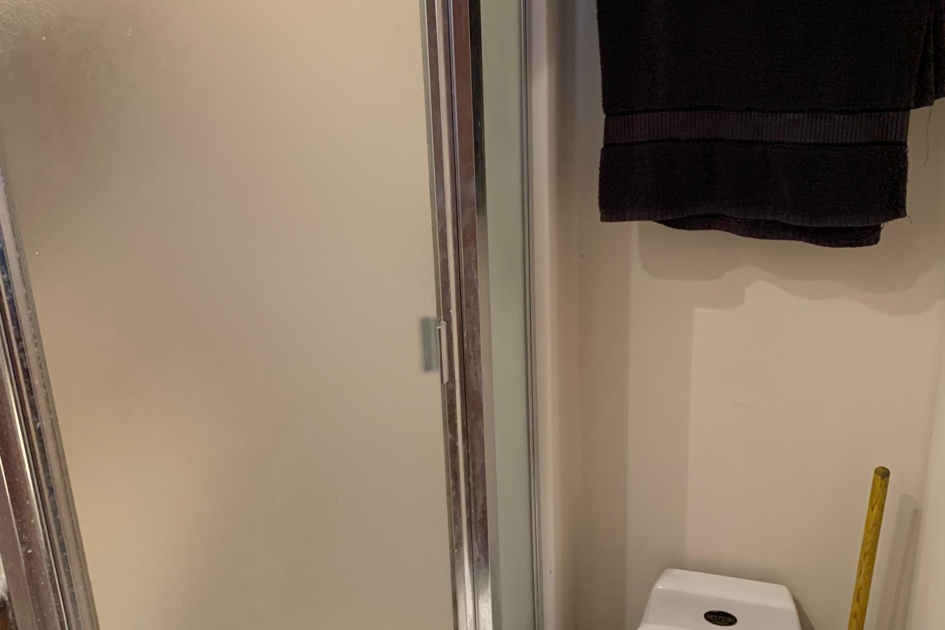 Bathroom interior of 1999 Bayliner 5788 Pilot House Motoryacht with shower and towel.