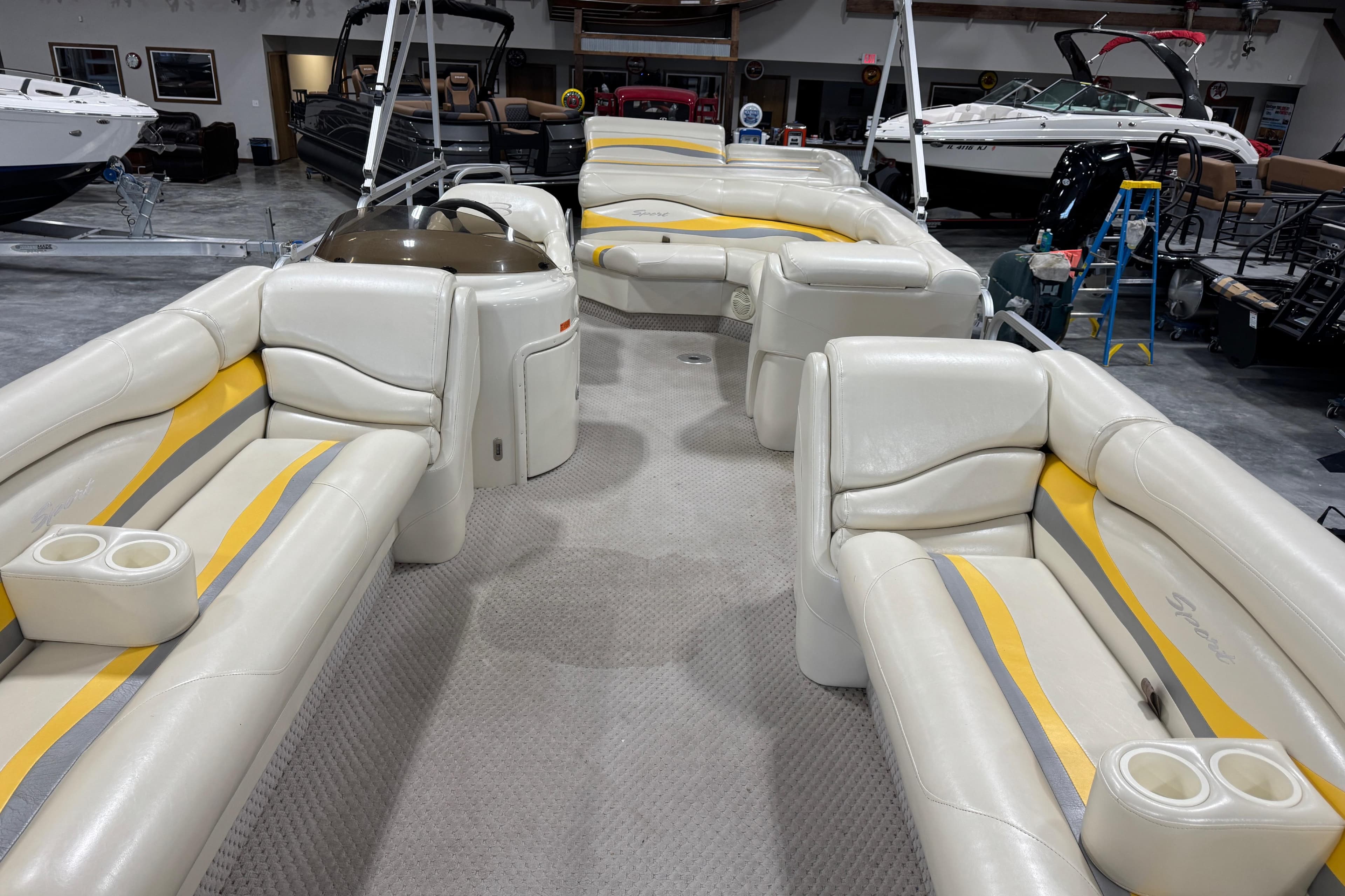 Interior of a 2005 Bennington 2575 RL pontoon boat with white and yellow seating.