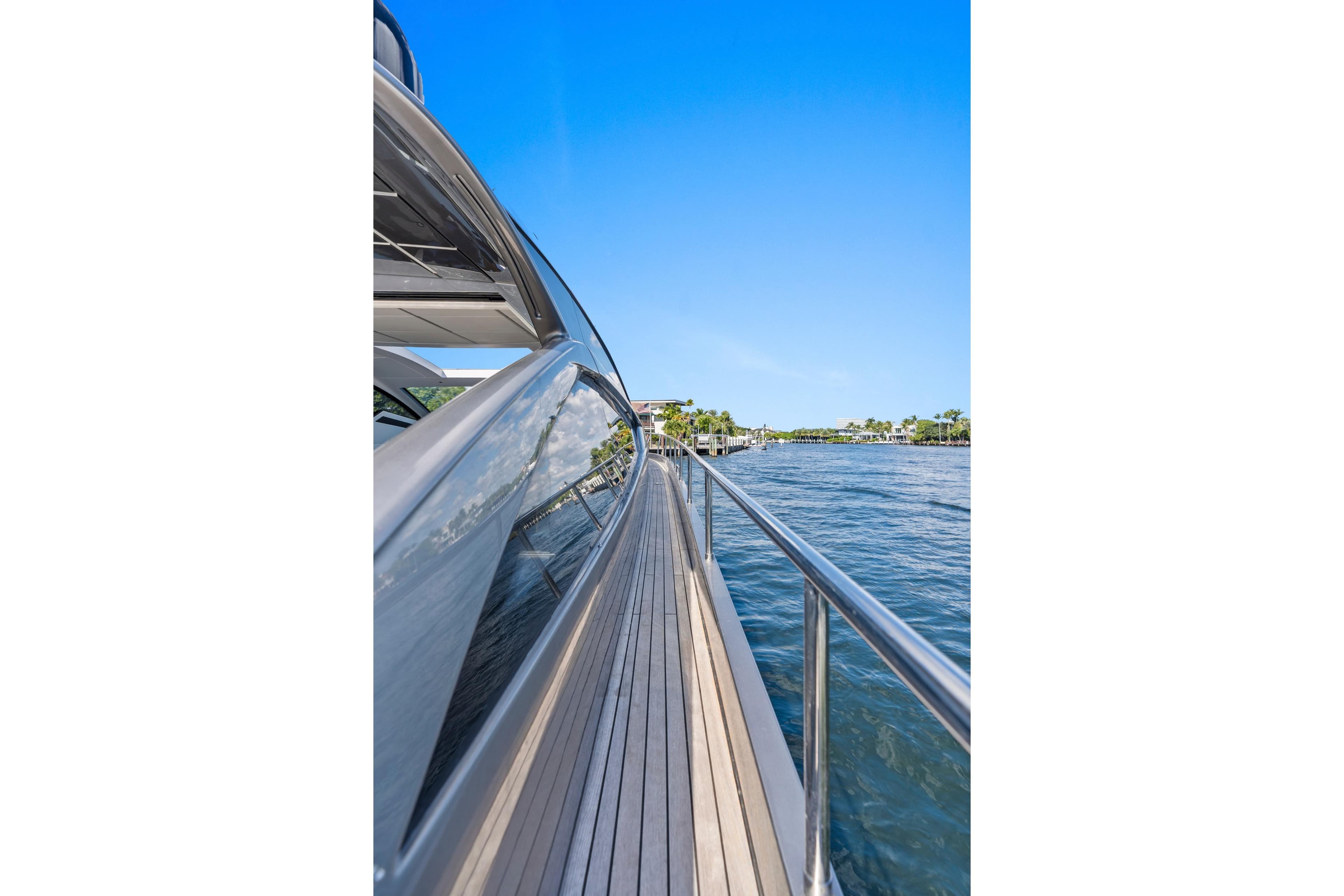 Side view of a 2016 Pershing 62' yacht on a sunny day.