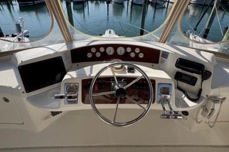 2008 Silverton 36 Convertible yacht helm with steering wheel and control panel.
