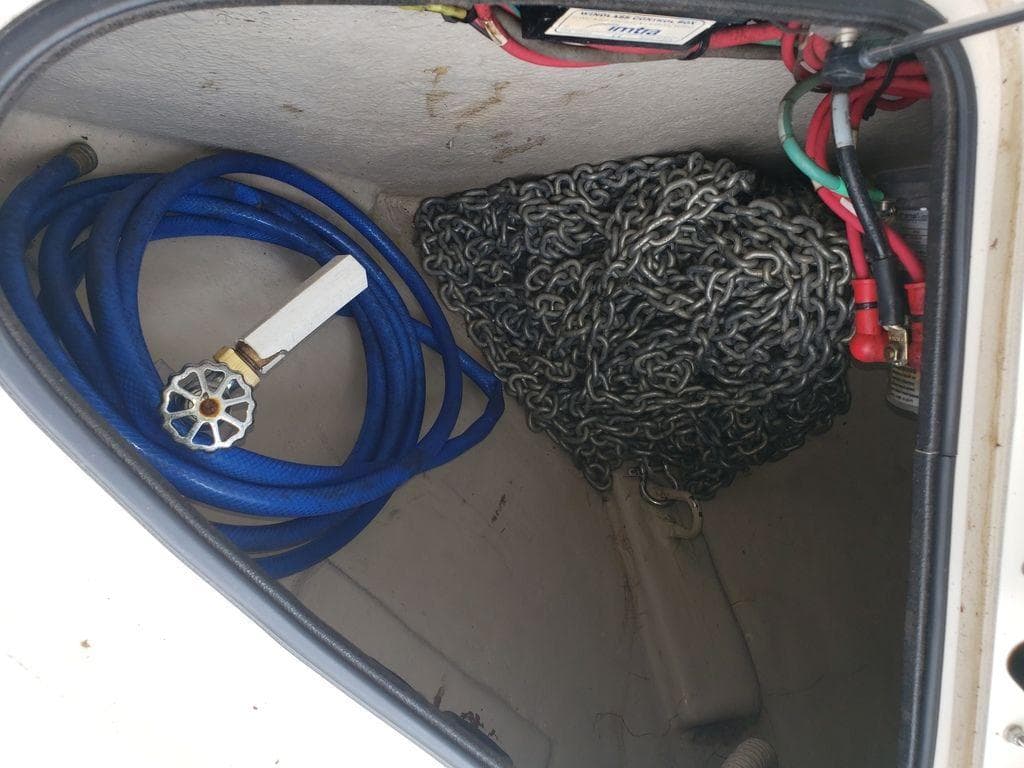 Storage compartment of a 2008 Sea Ray 38 Sundancer with hose and anchor chain.