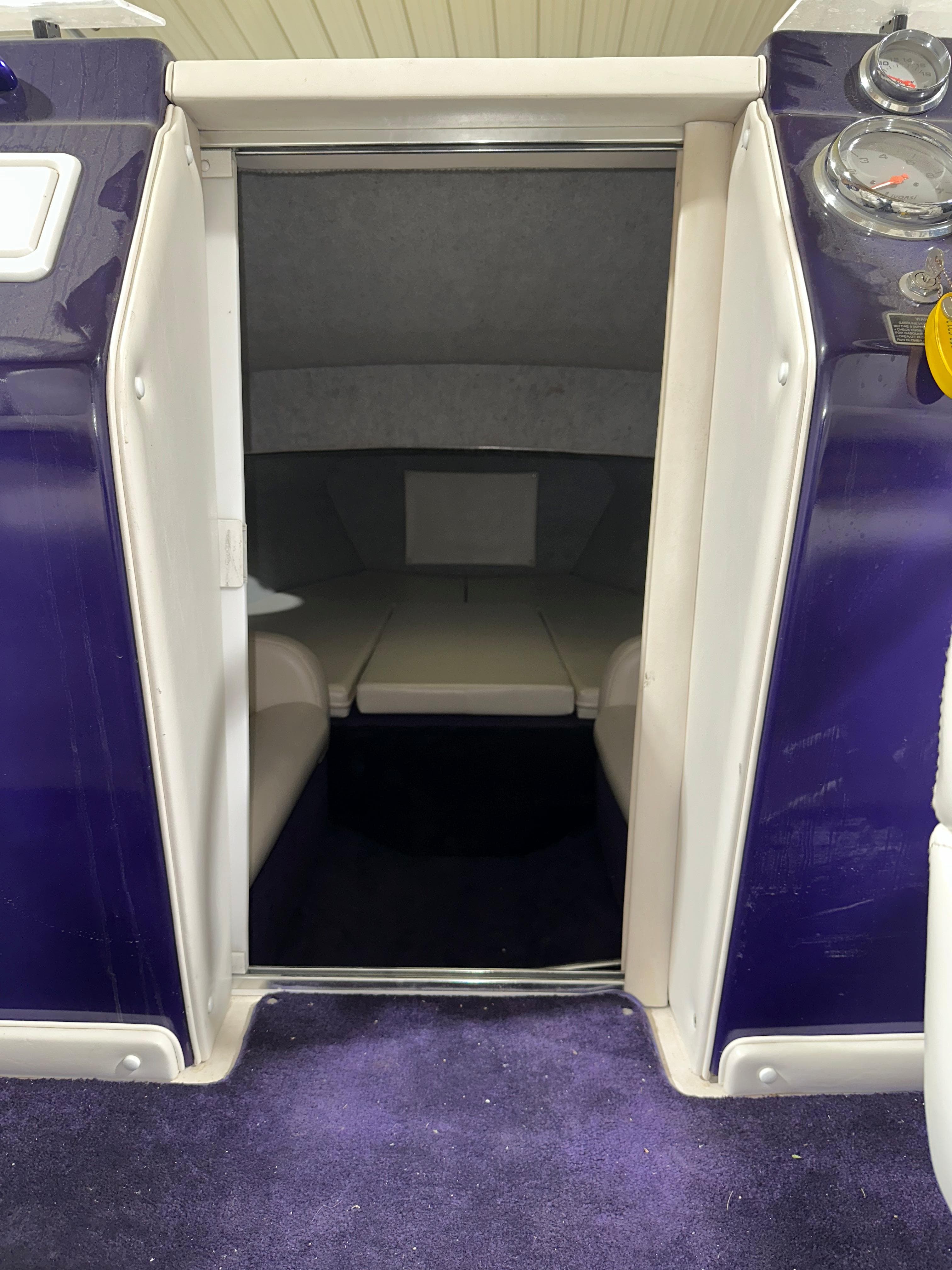 2005 Eliminator 260 Eagle XP cabin interior with purple accents and seating area.