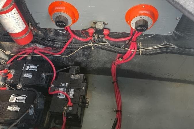Electrical system of a 1991 Sea Ray 280 Weekender boat, featuring batteries and wiring.