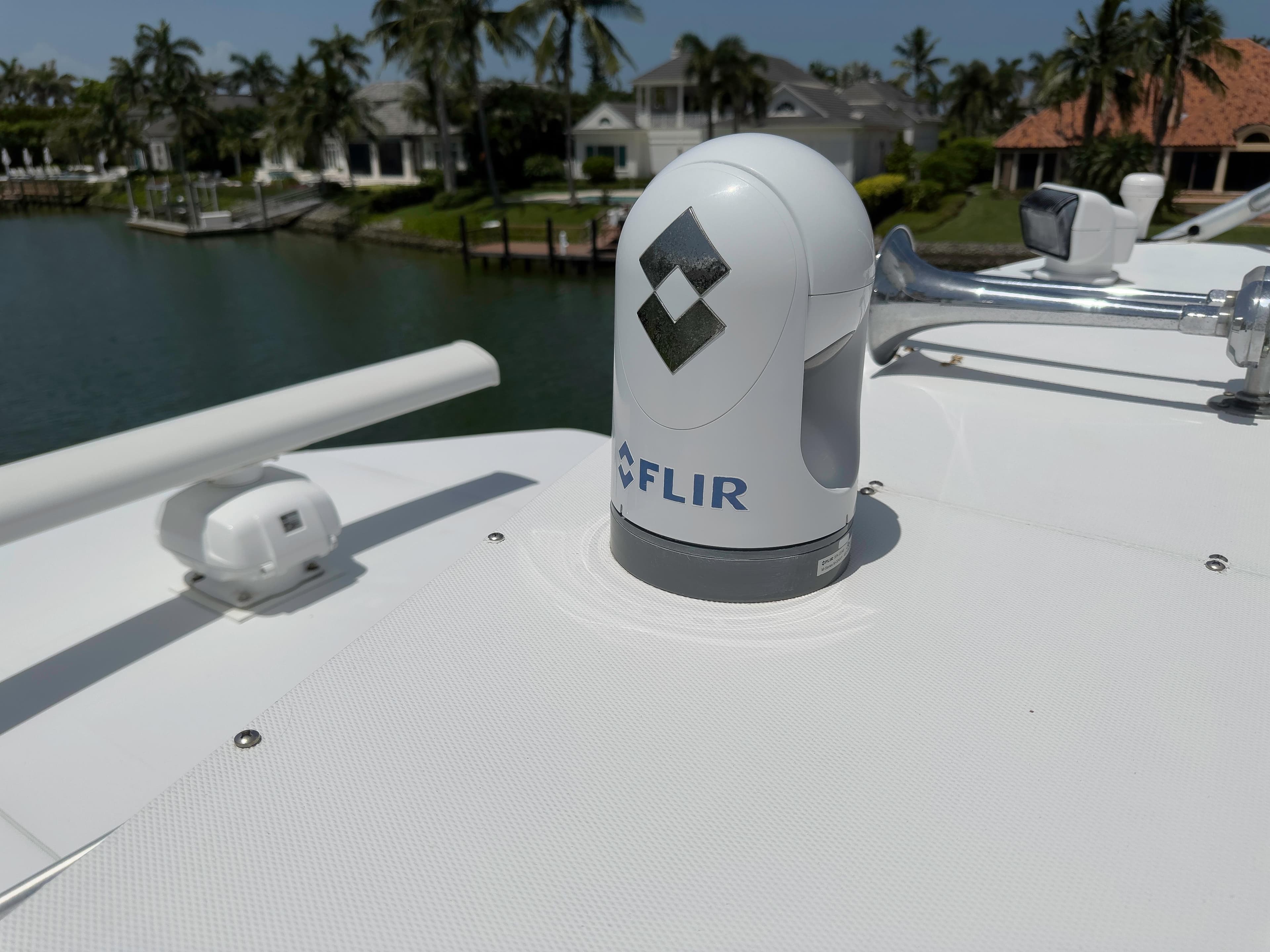 FLIR camera on 1990 Buddy Davis 61 Convertible yacht, docked near waterfront homes.