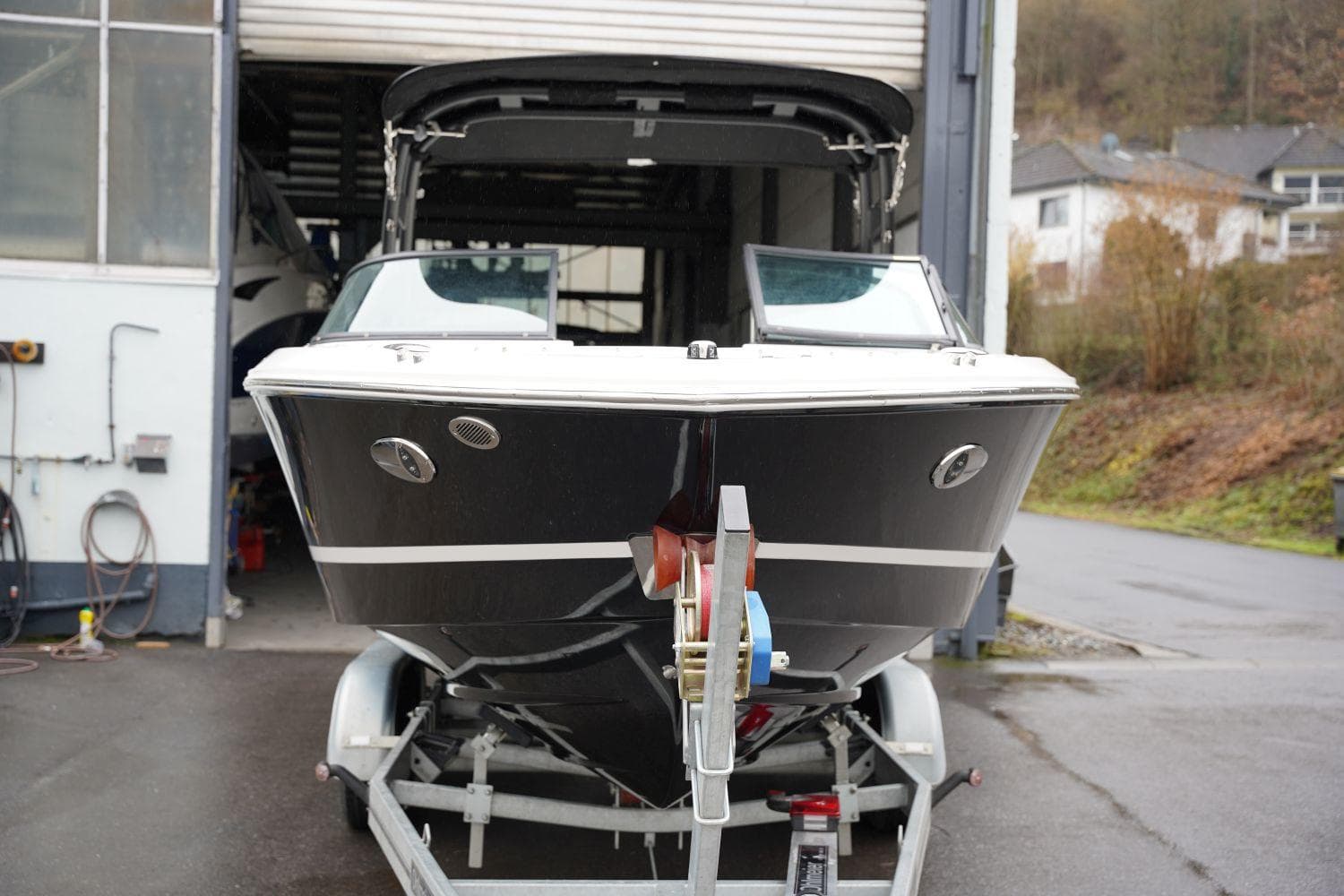 2023 Regal LS2 boat on trailer in garage, front view.