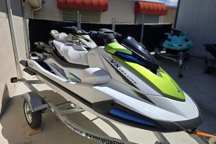 2026 Yamaha WaveRunner VX Deluxe in vibrant green and white on a trailer.