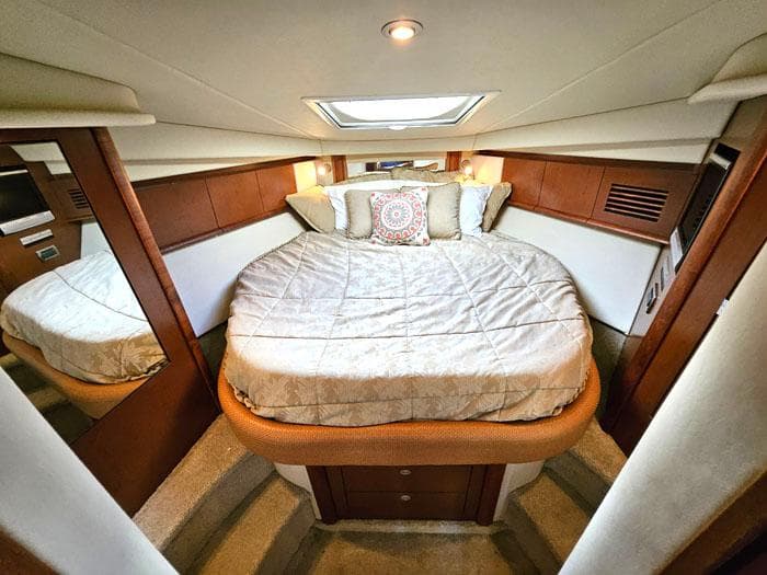 Luxurious cabin interior of 2007 Sea Ray 40 Sundancer yacht with cozy bedding.
