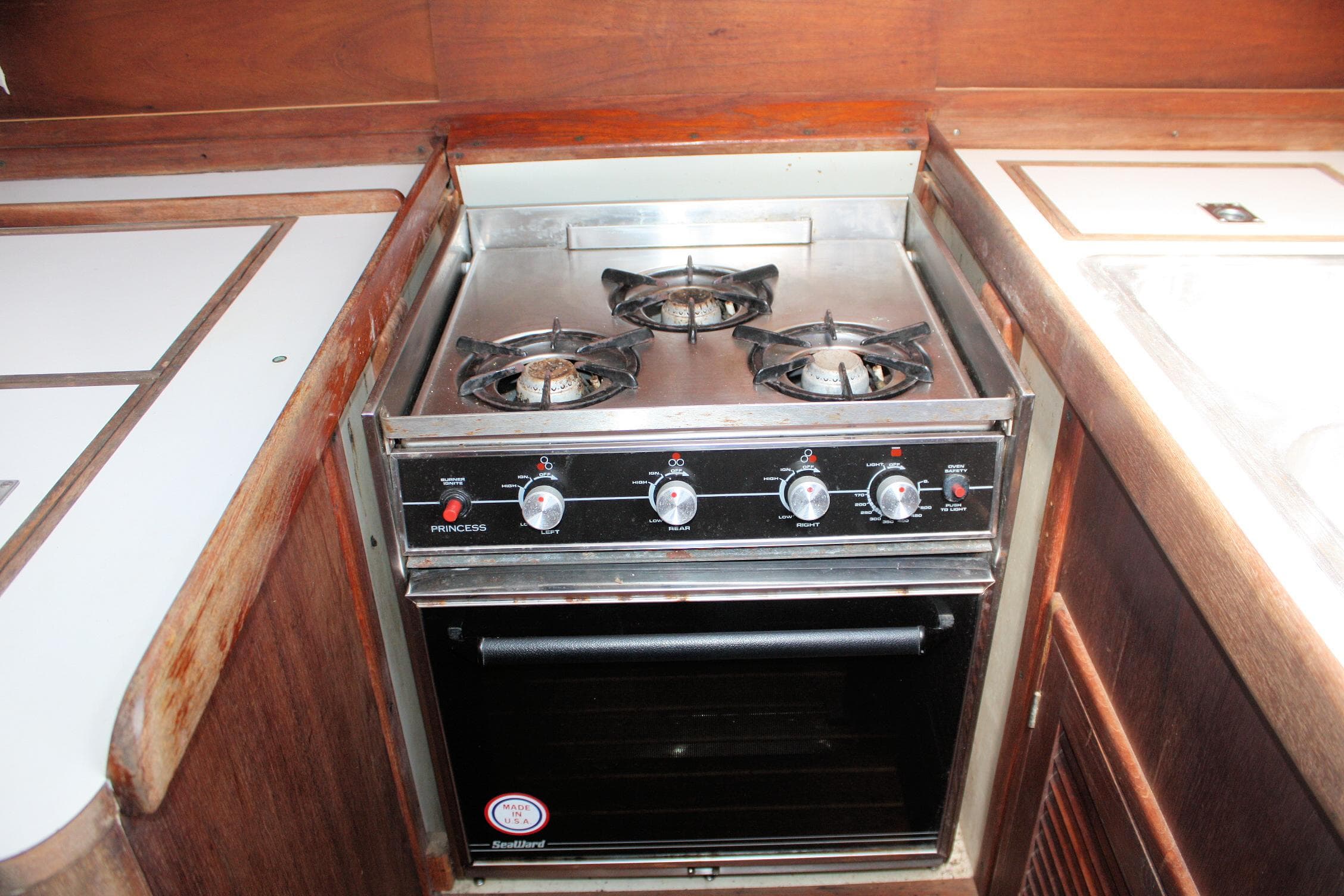 1978 Tartan 37 yacht kitchen with a three-burner stove and oven.