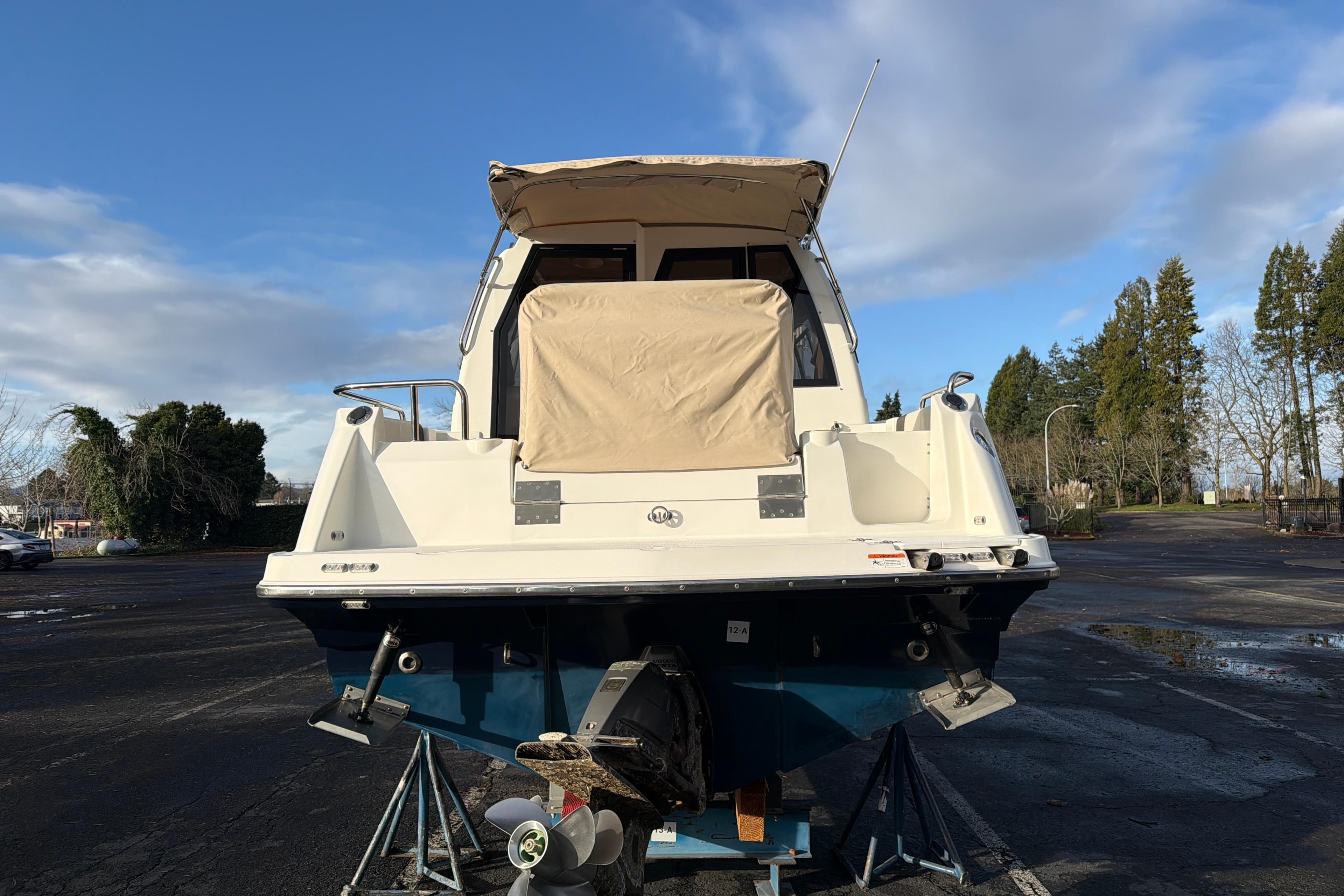 2016 Cutwater C-242 Coupe boat on a trailer, rear view, under a clear sky.