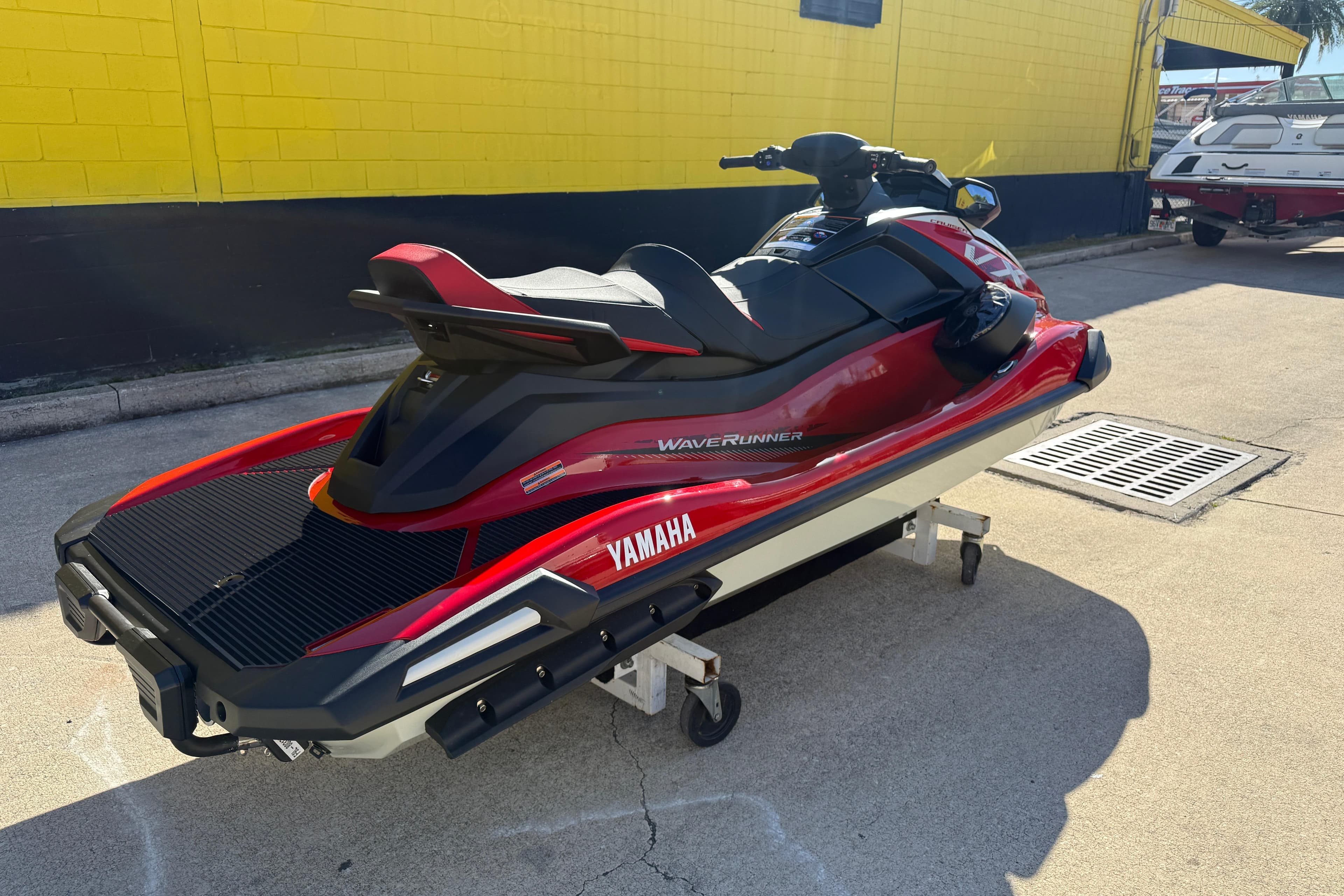 2026 Yamaha WaveRunner VX Cruiser in red, parked outdoors on a sunny day.