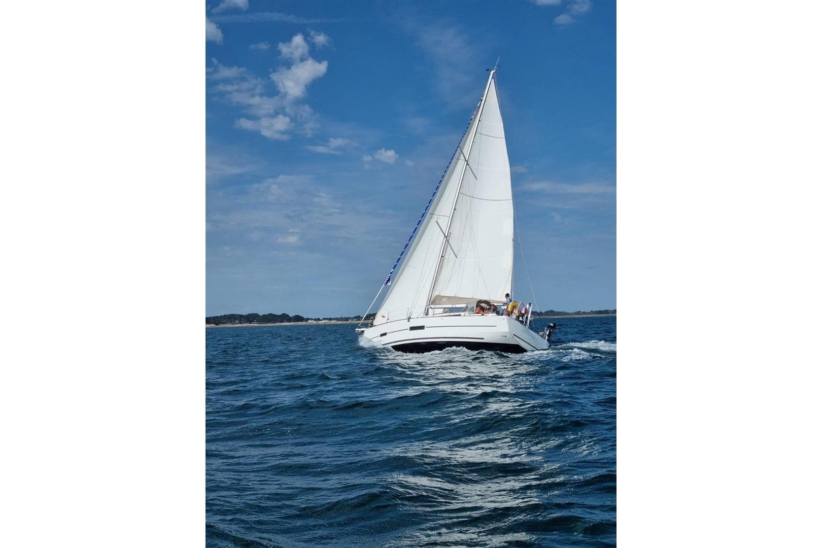 Sailing yacht Dufour 382 Grand Large 2018 on open water under clear blue sky.
