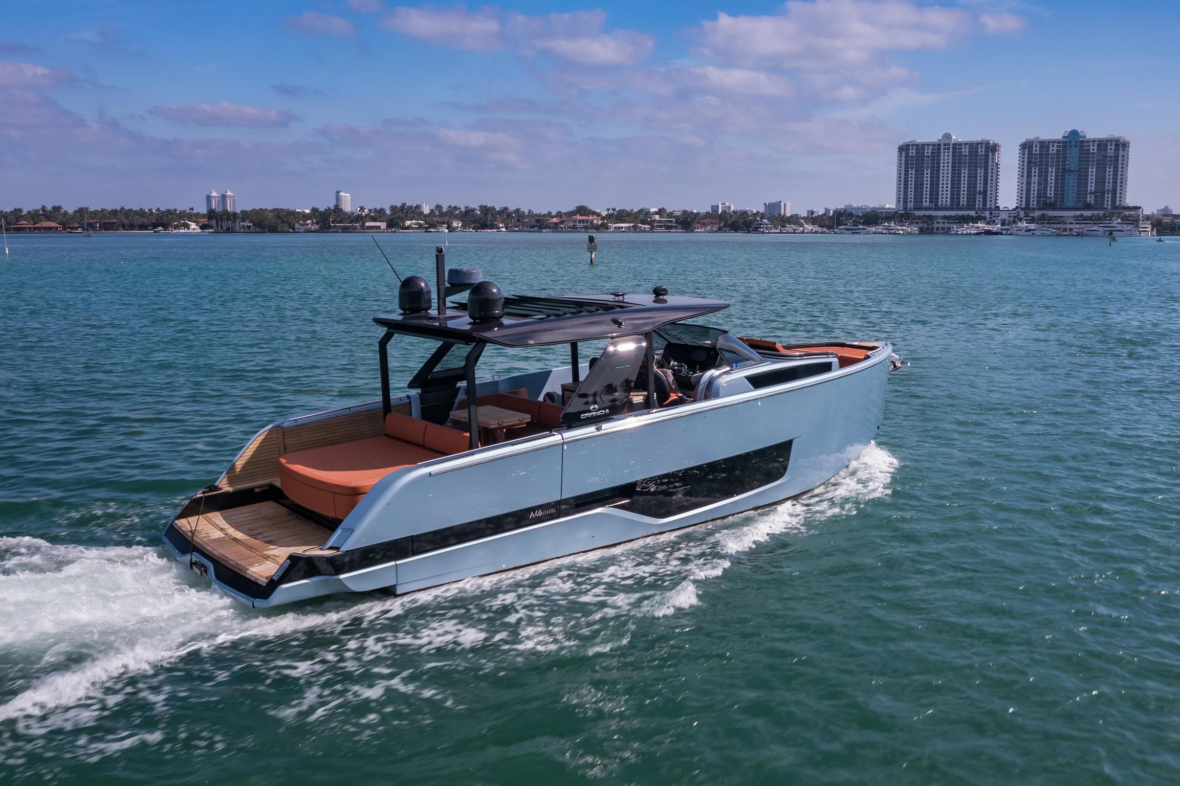 2022 Cranchi A46 Luxury Tender cruising on a sunny day near urban skyline.