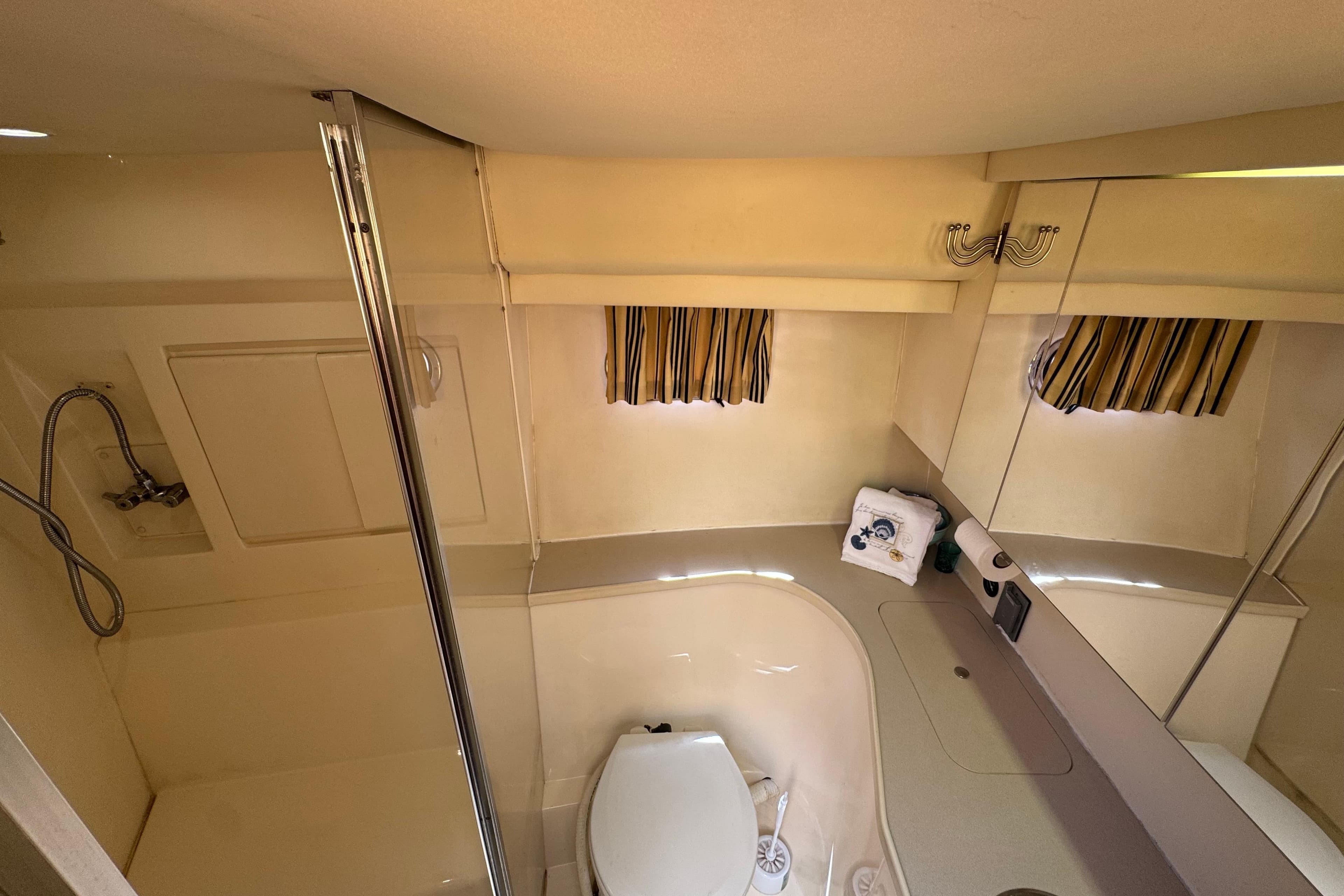 Bathroom interior of 1996 Carver 370 Voyager yacht, featuring shower and toilet.